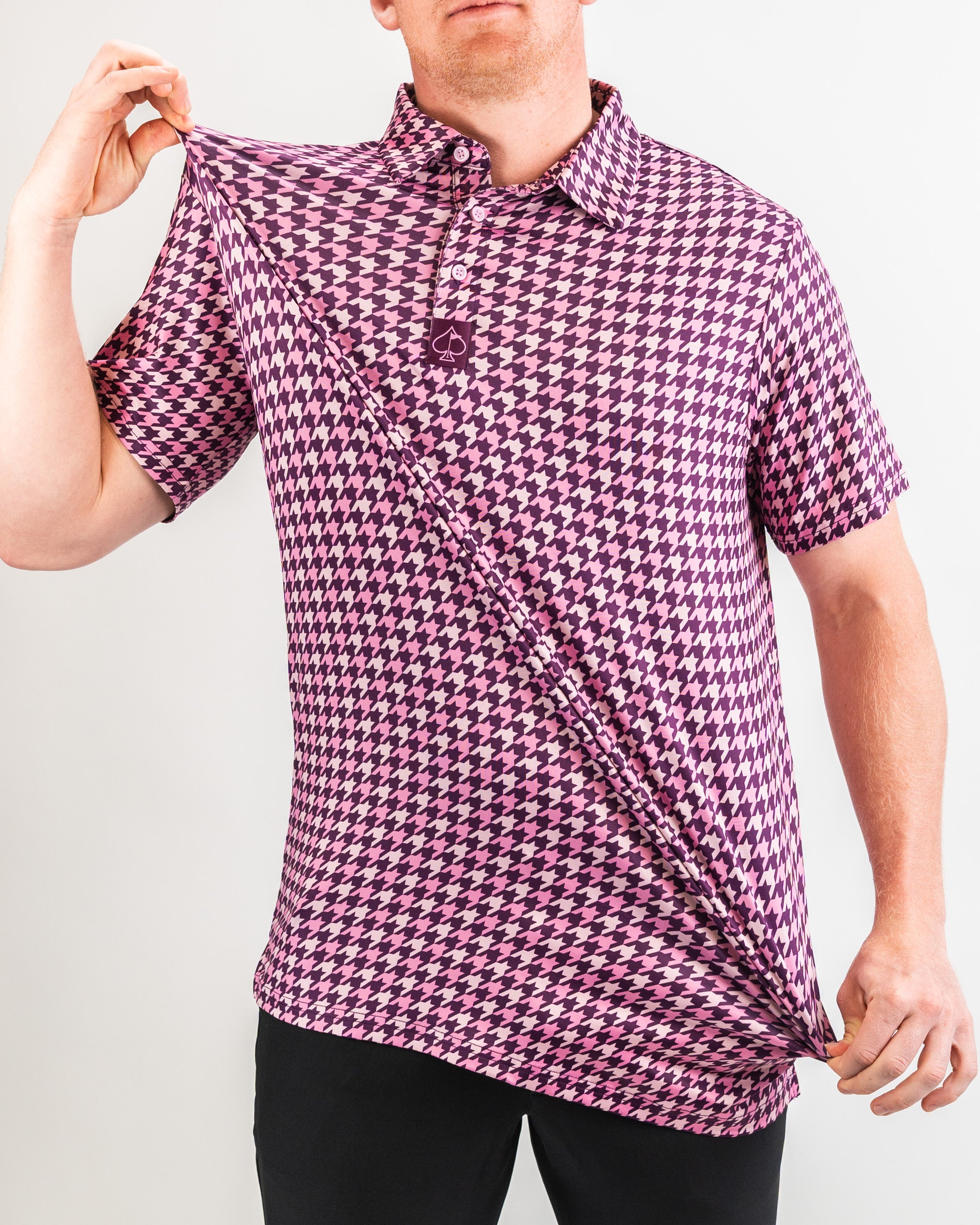 Houndstooth patterned fabric in raspberry color, featuring a classic design with bold contrasts.