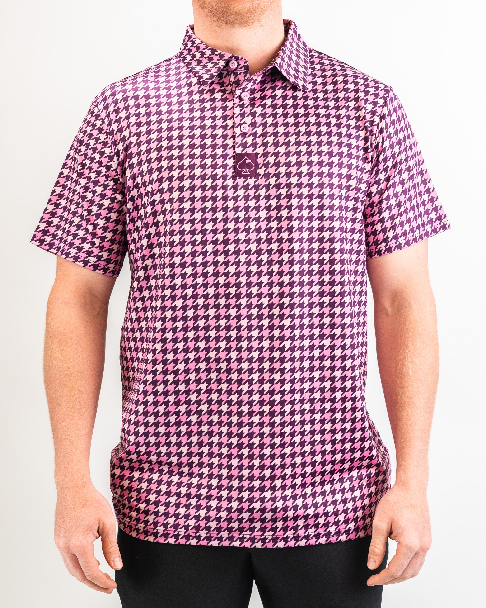 Alt text: Houndstooth pattern in raspberry color on a men's shirt, showcasing a close-up of fabric texture and design.