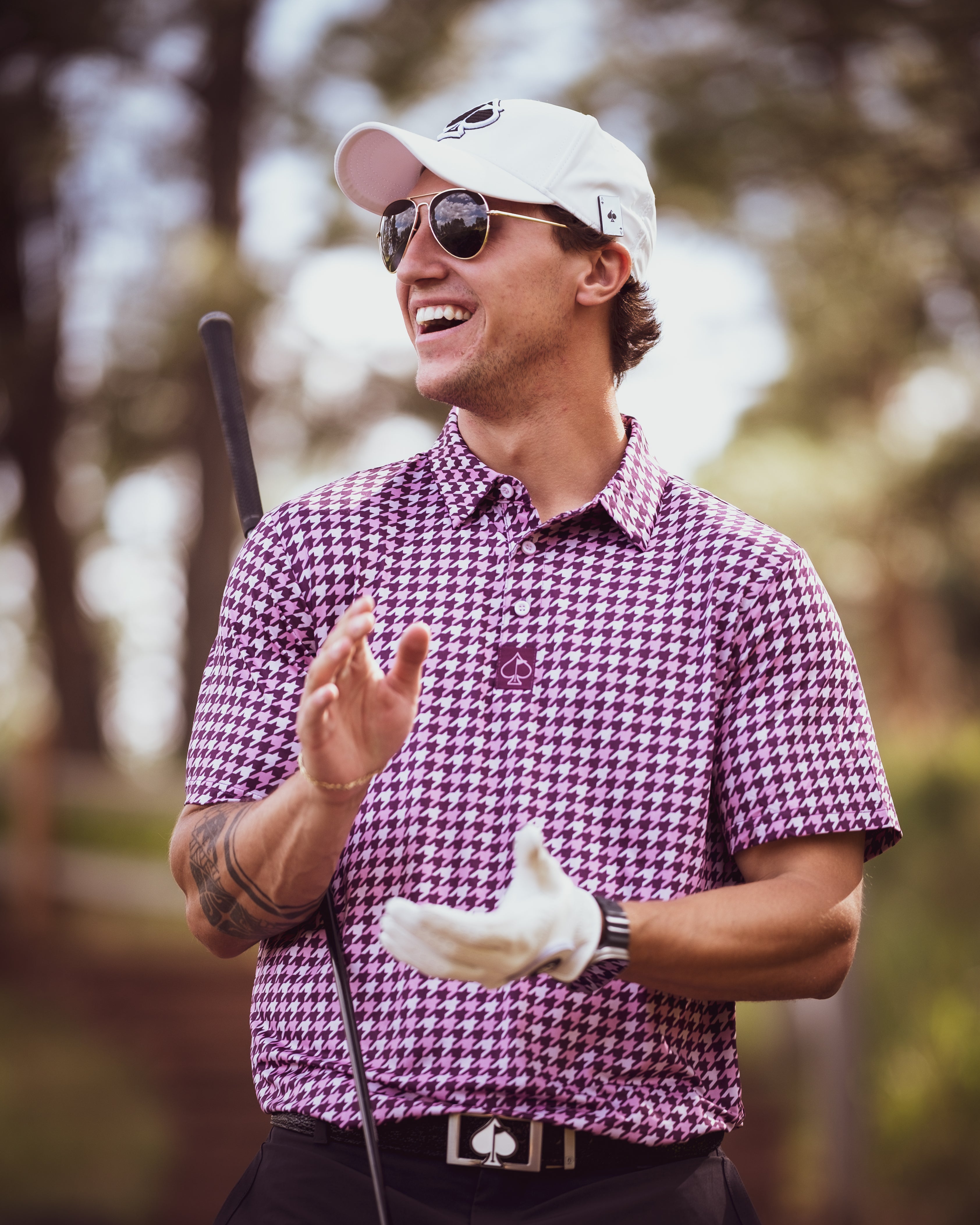 Houndstooth pattern hoodie in raspberry with tropical shatter design, worn outdoors.