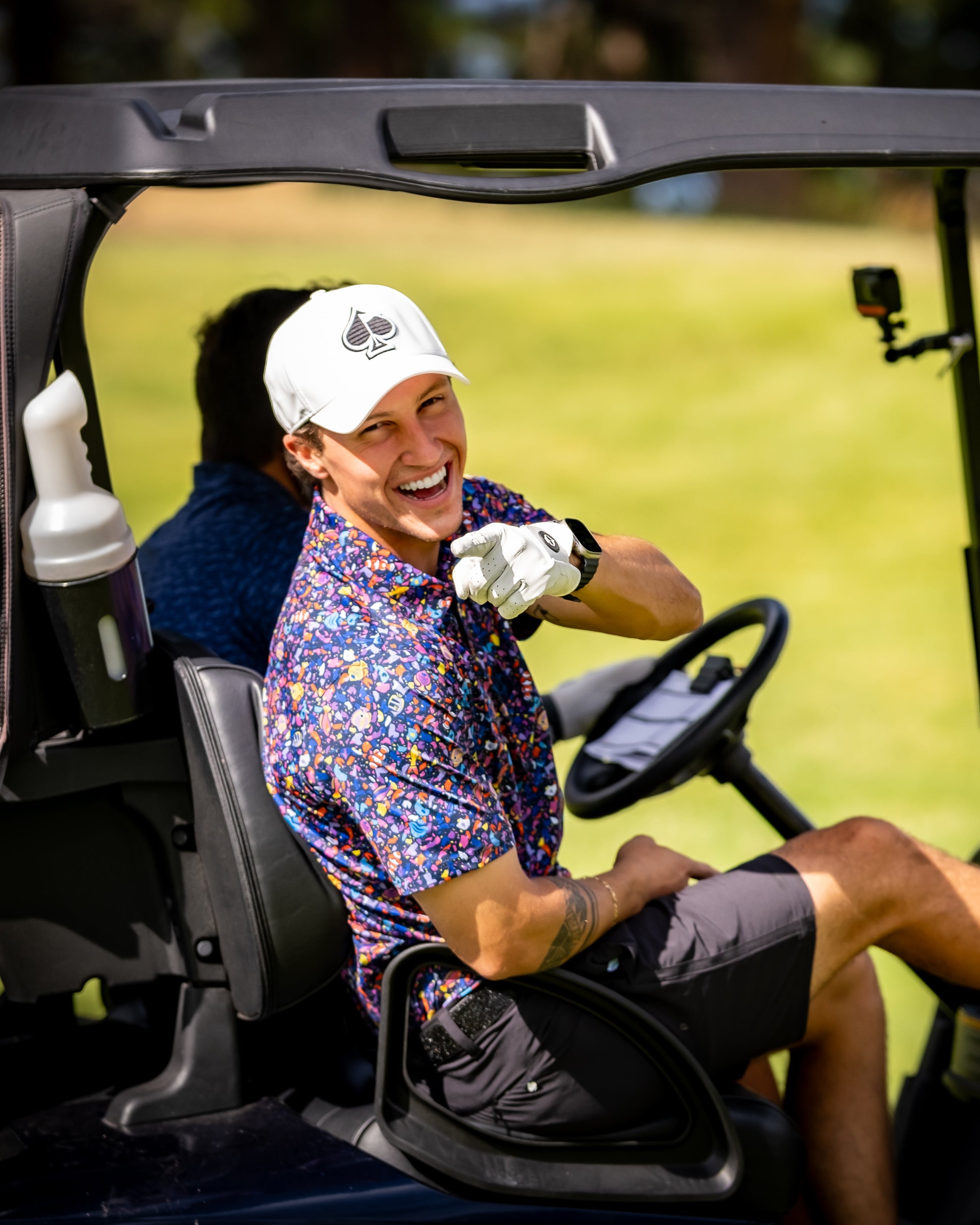 Alt text: Tropical Shatter hoodie featuring a vibrant raspberry houndstooth pattern, showcased in a lifestyle setting.