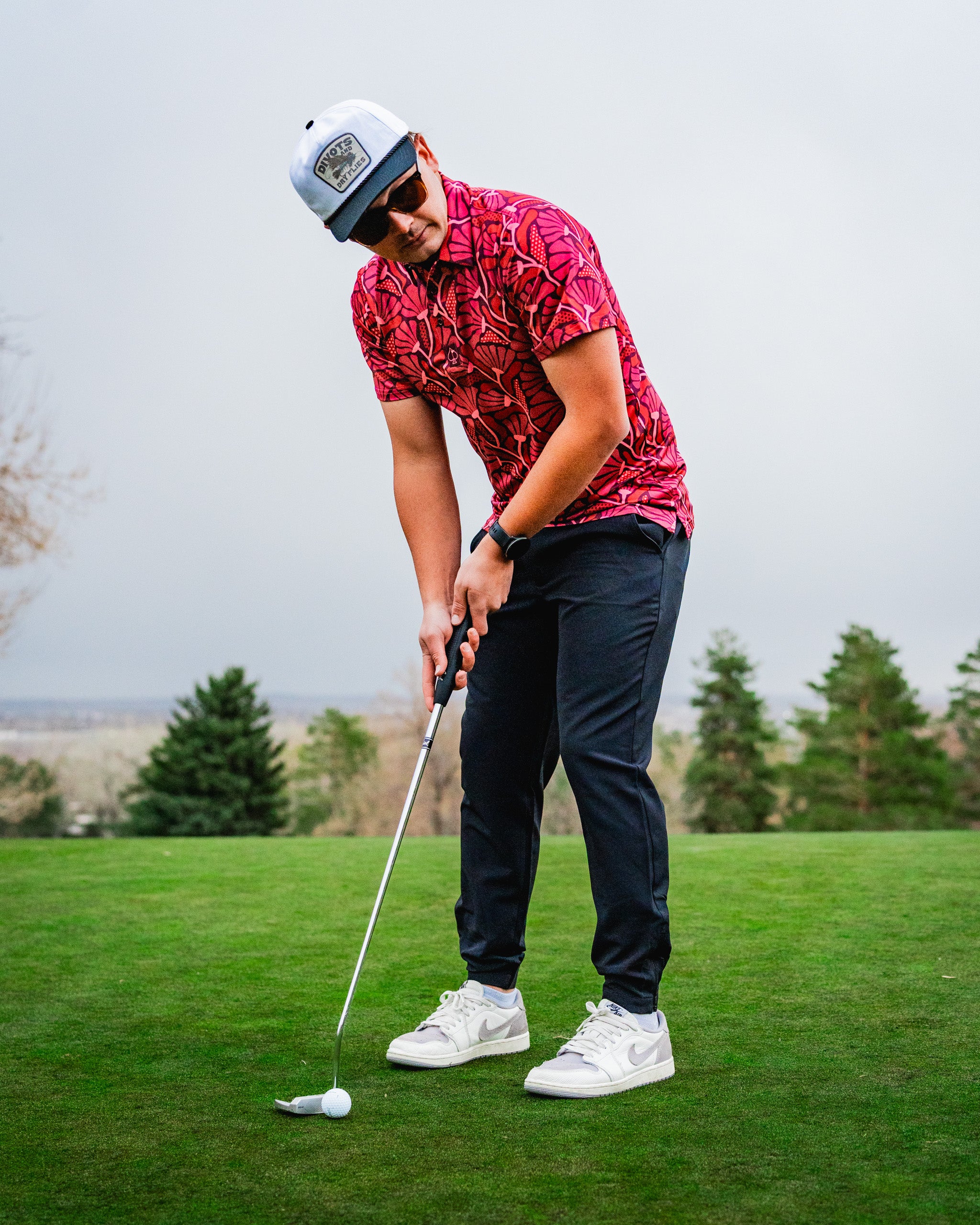 "Vibrant crimson blooms in a lush garden setting, showcasing a variety of flowers with green foliage."