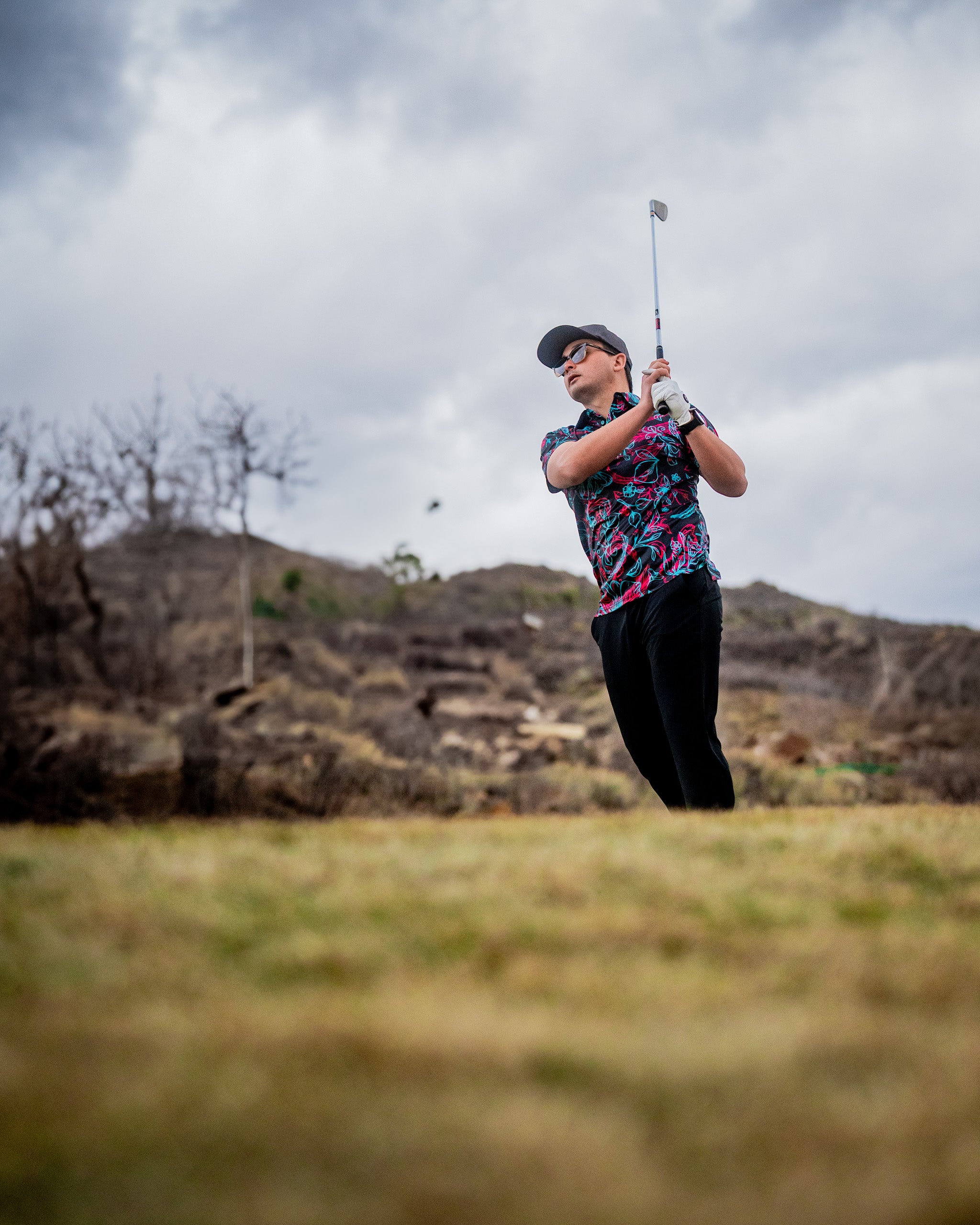 Cabo Electric rolling hills landscape with vibrant green grass under a clear blue sky.