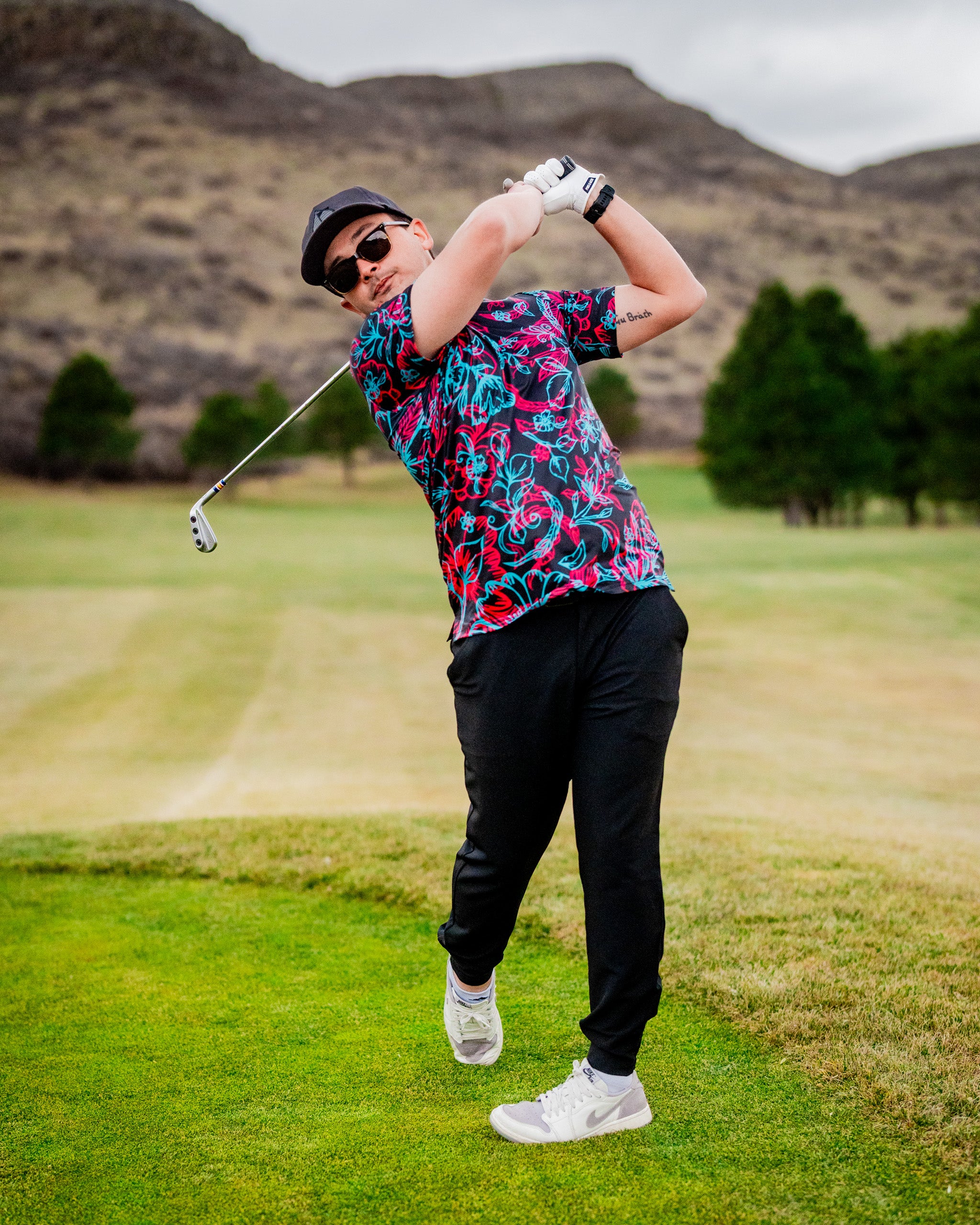 Cabo Electric electric scooter with a sleek design, featuring a comfortable seat and durable wheels, parked against a scenic backdrop of rolling hills.