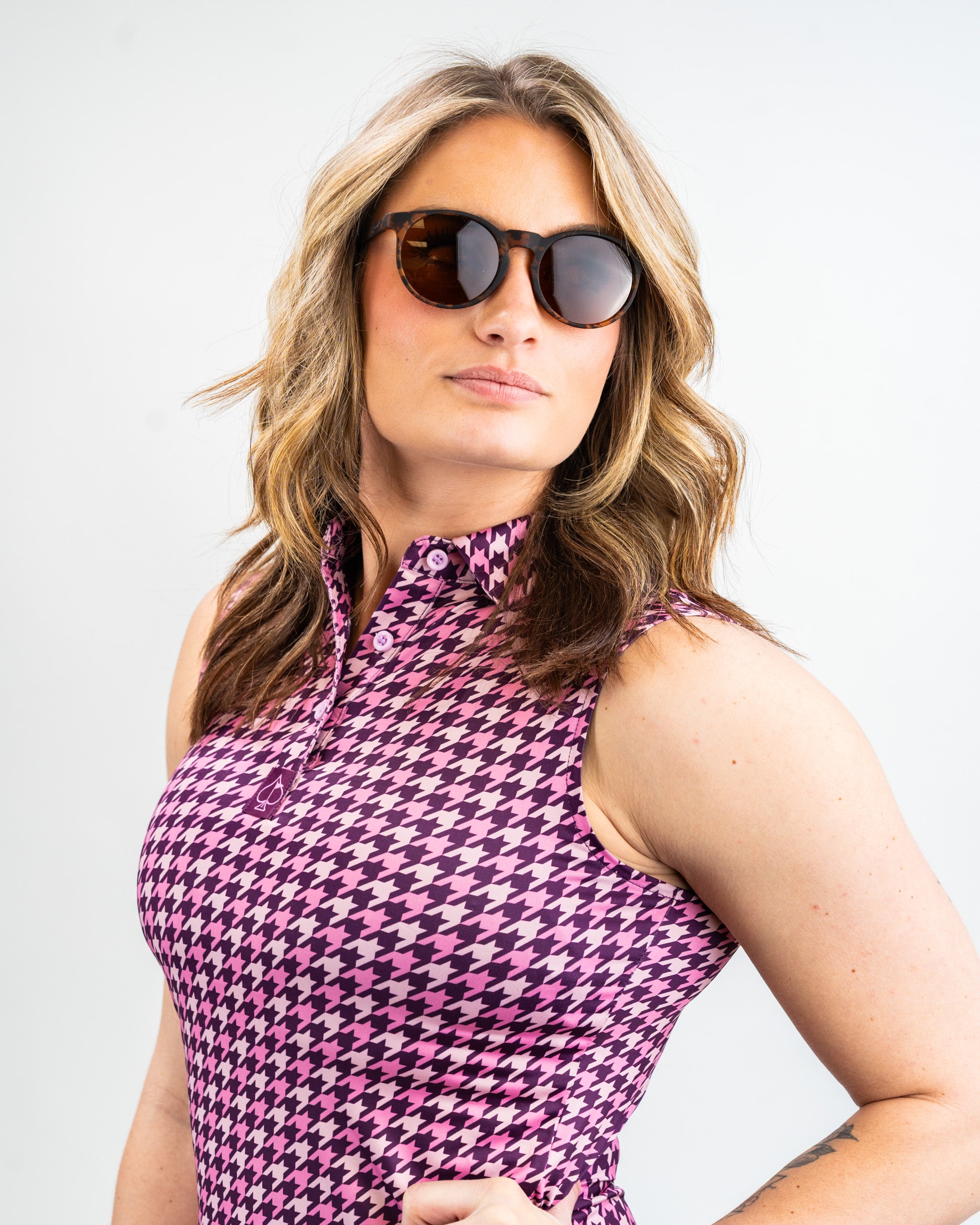 Women's houndstooth patterned dress in raspberry color, featuring a fitted silhouette and short sleeves.