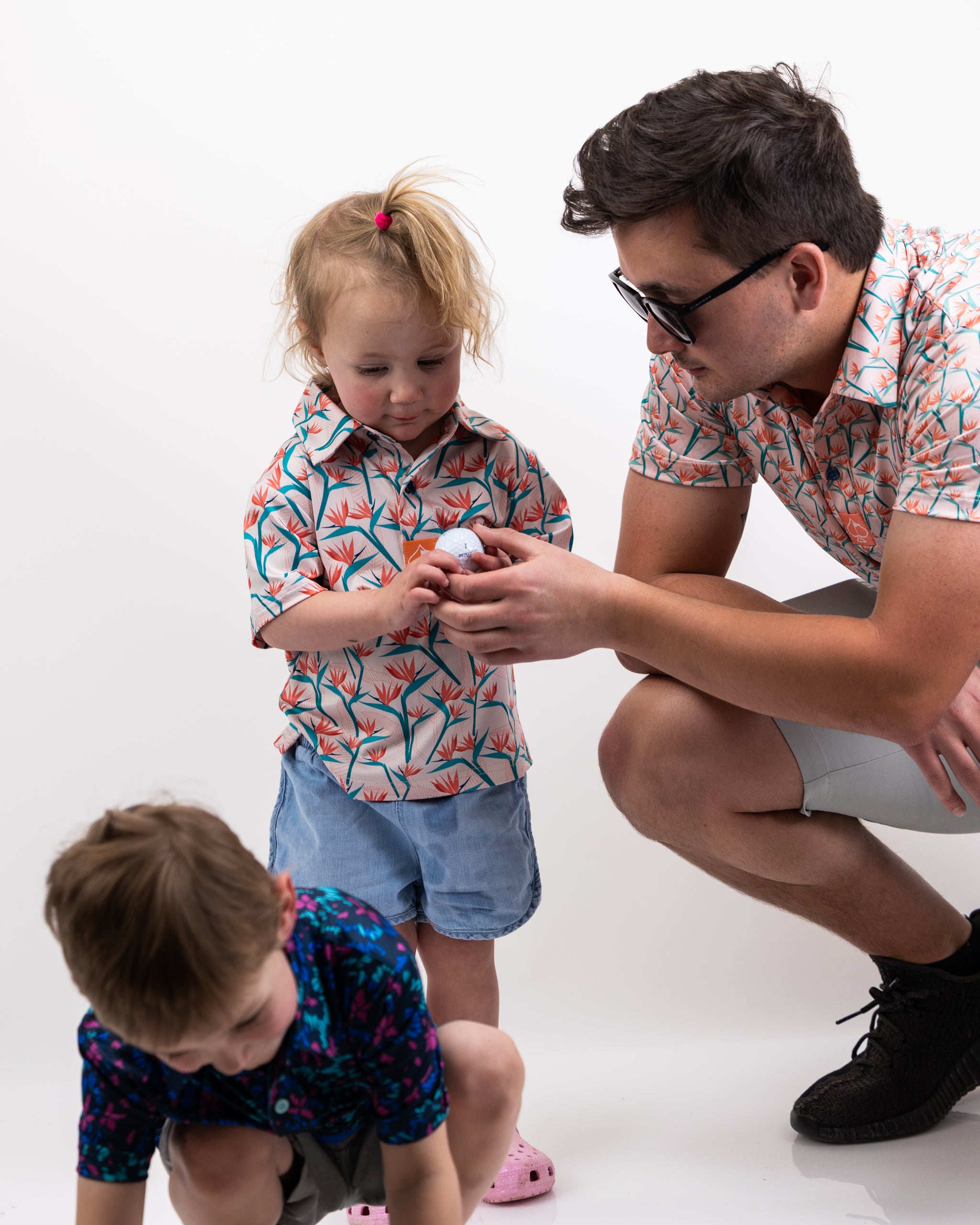 Youth Birds of Paradise dress with vibrant tropical print, showcasing colorful birds and lush foliage in a playful design for kids.