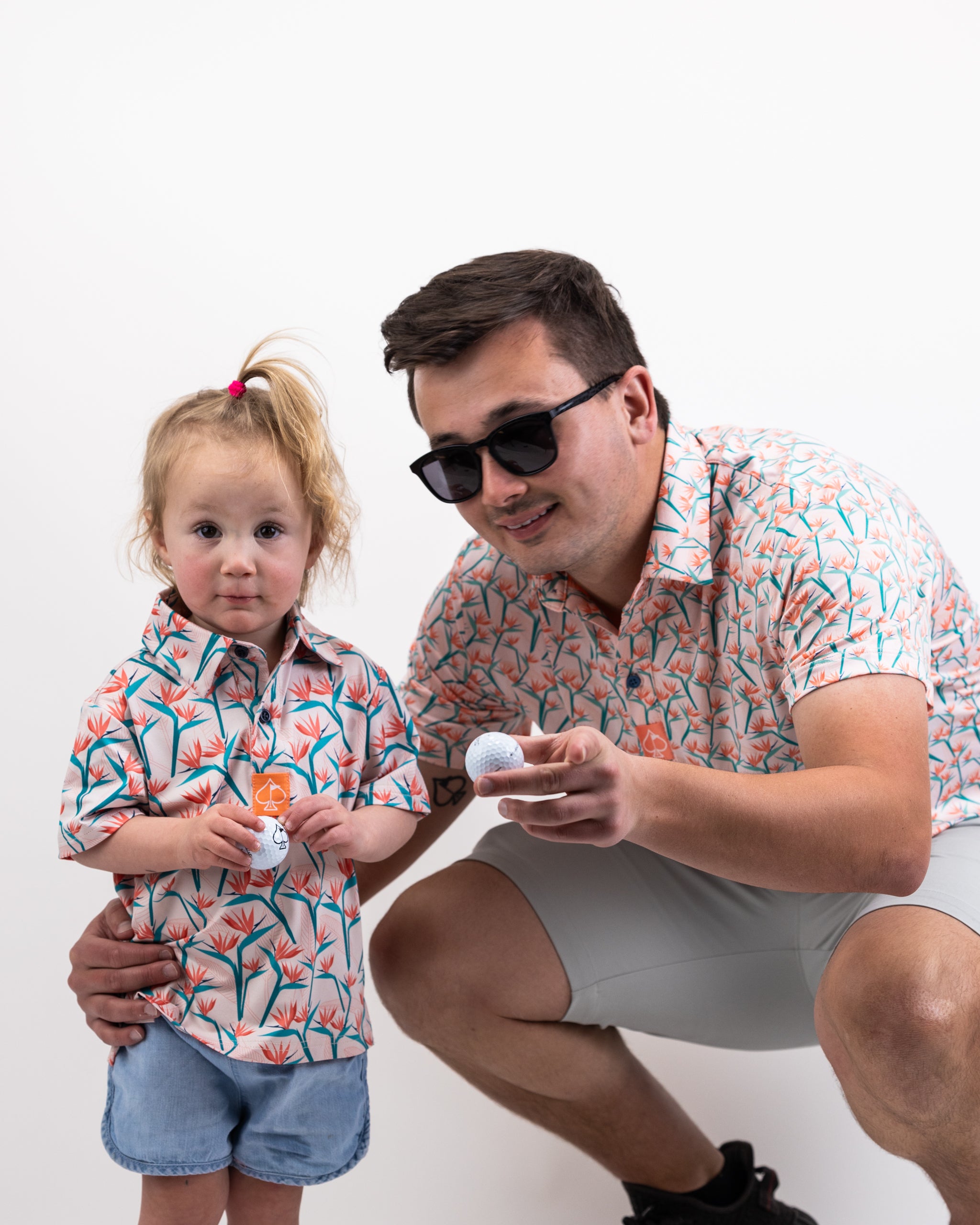 Youth Birds of Paradise dress featuring vibrant tropical print and ruffled sleeves, perfect for stylish summer outfits.