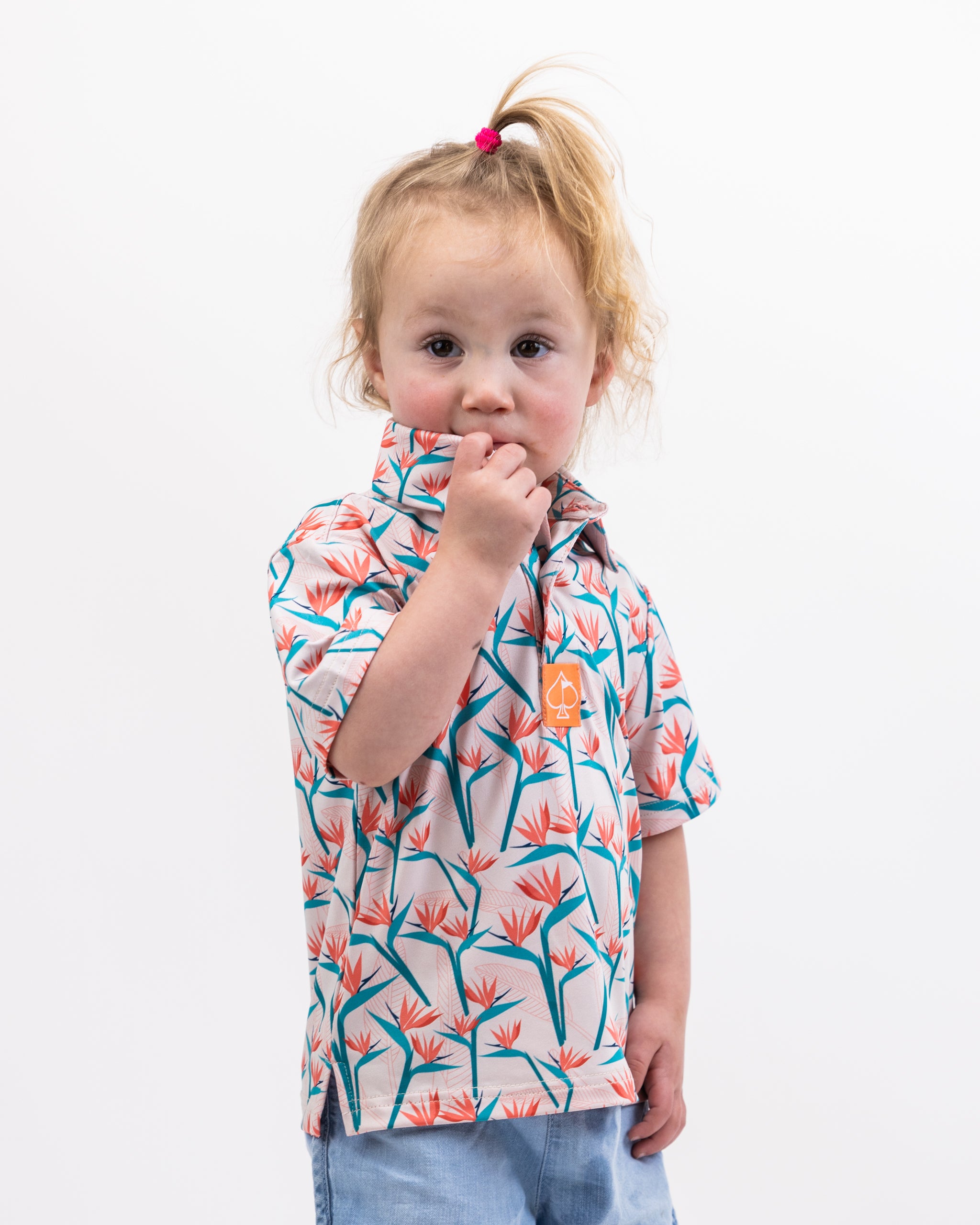 Youth Birds of Paradise dress featuring vibrant floral patterns and a playful design.