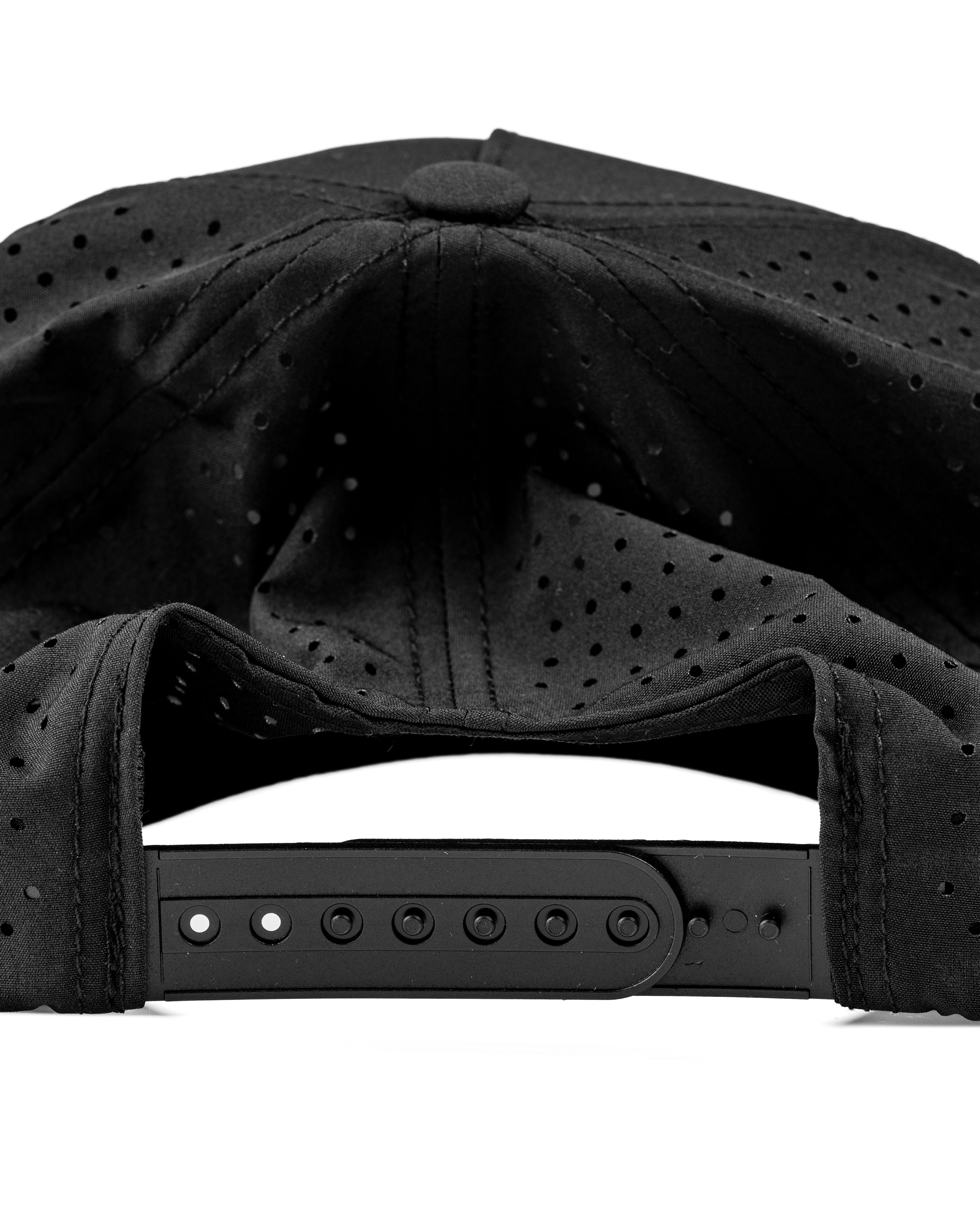 Perforated black rope hat with adjustable strap, designed for golfers seeking style and breathability on the course.