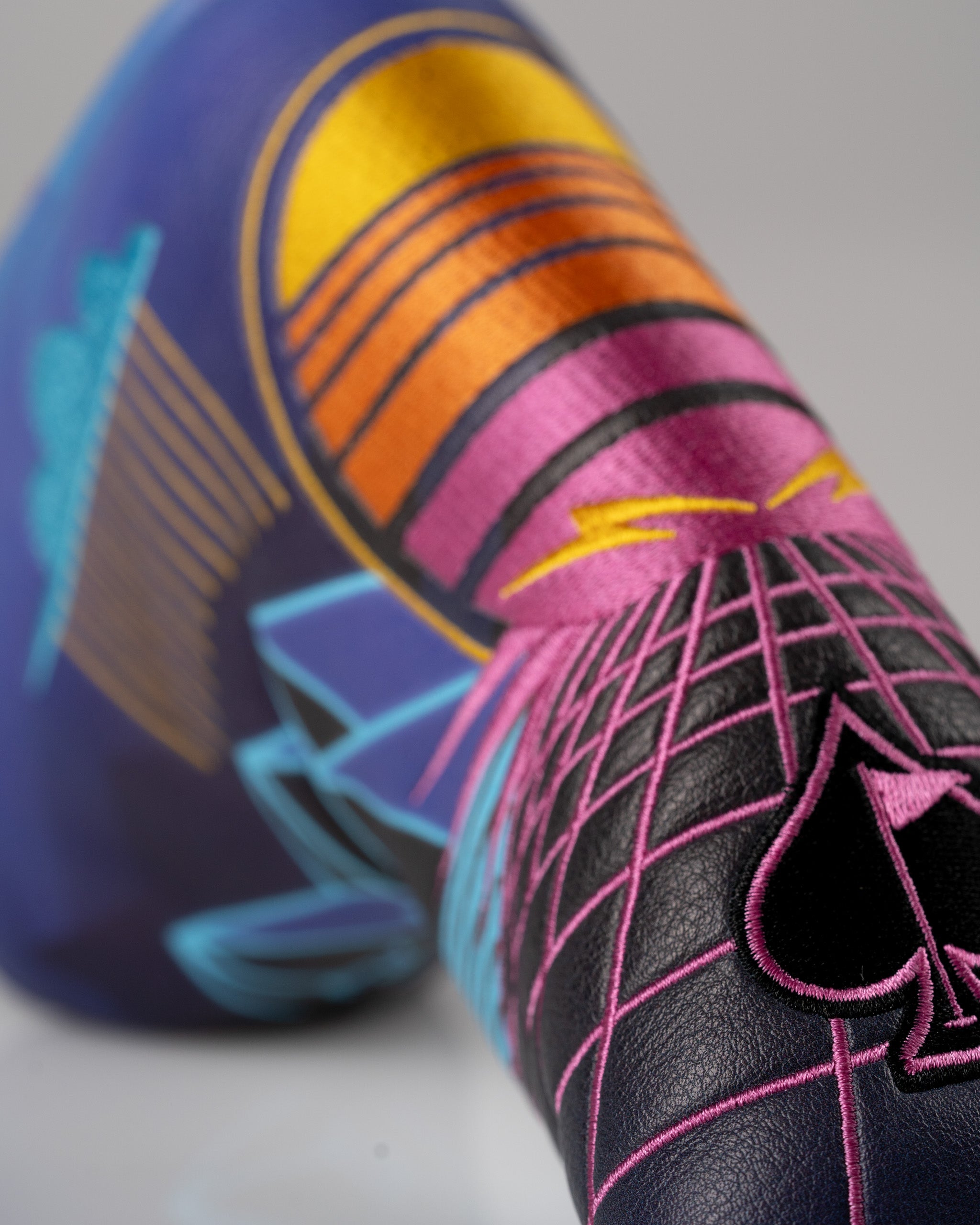 Bold Synthwave Blade Putter Cover featuring vibrant retro graphics and a sleek design for stylish golfers.