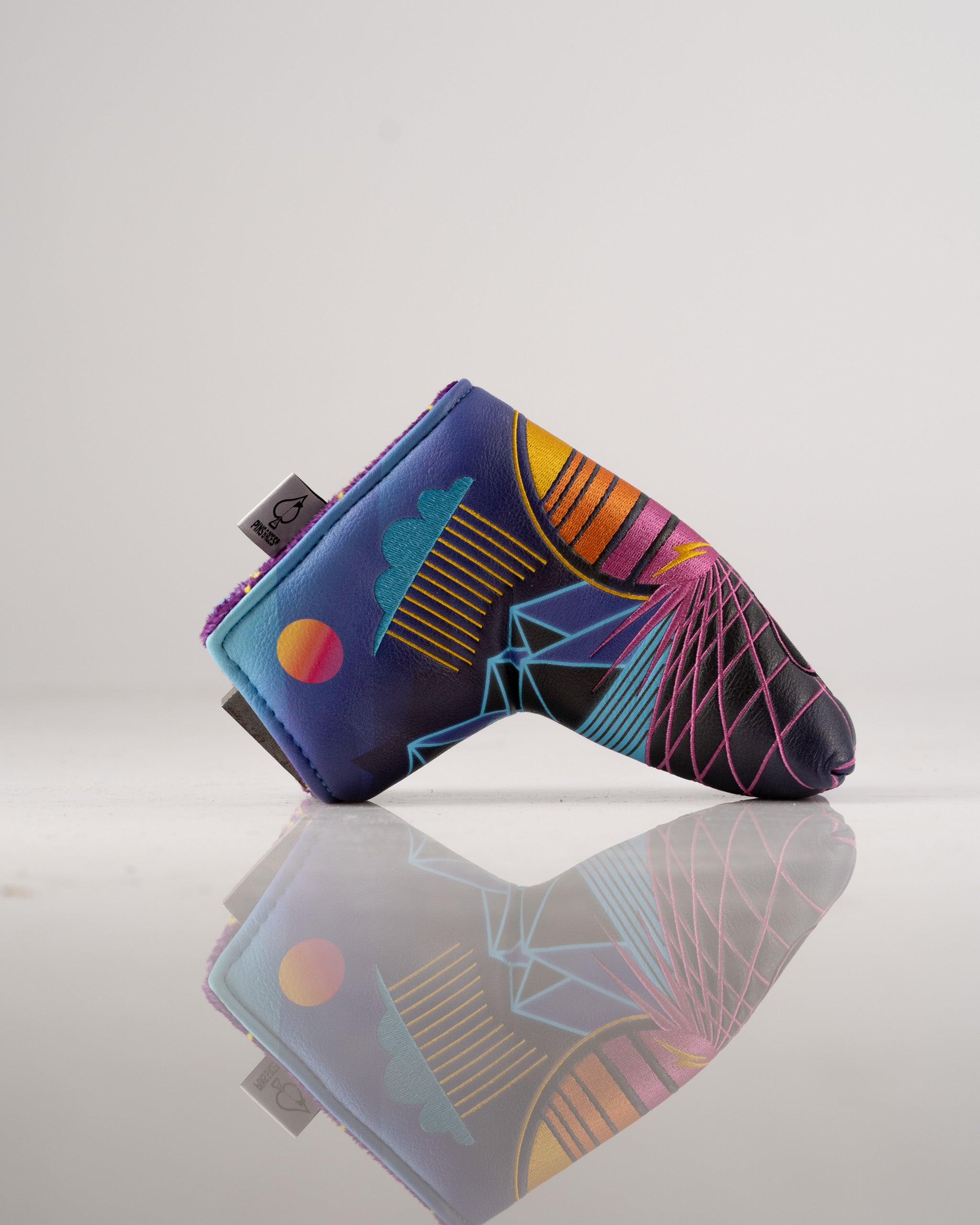 Bold Synthwave Blade Putter Cover featuring vibrant geometric designs and retro colors, perfect for stylish golfers.