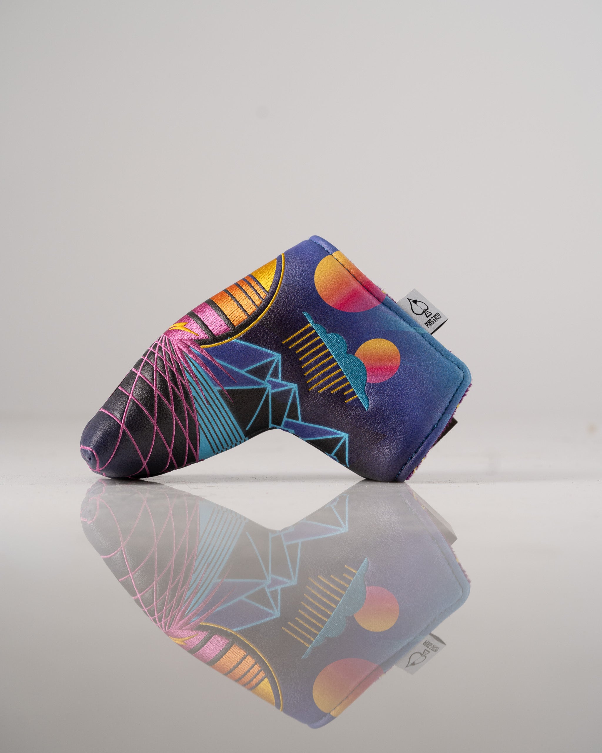 Bold Synthwave Blade Putter Cover featuring vibrant colors and geometric patterns, perfect for stylish golfers.