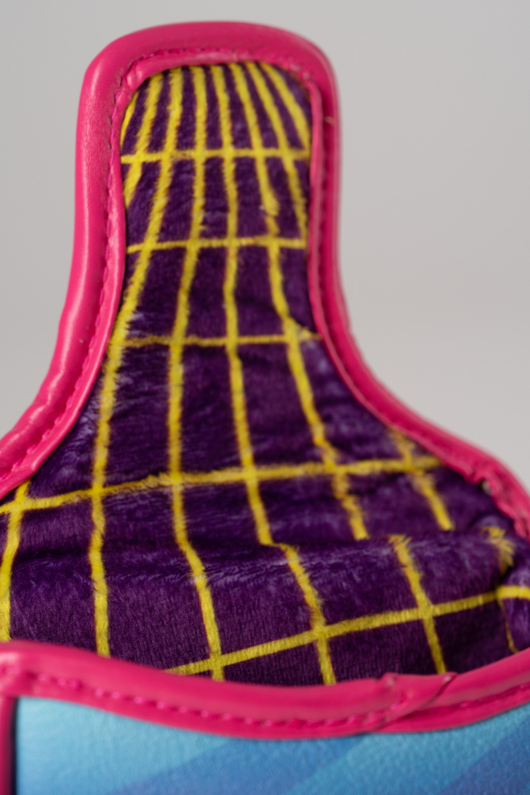 Vibrant pink mallet putter cover featuring a retro synthwave design with a purple and yellow grid pattern interior.