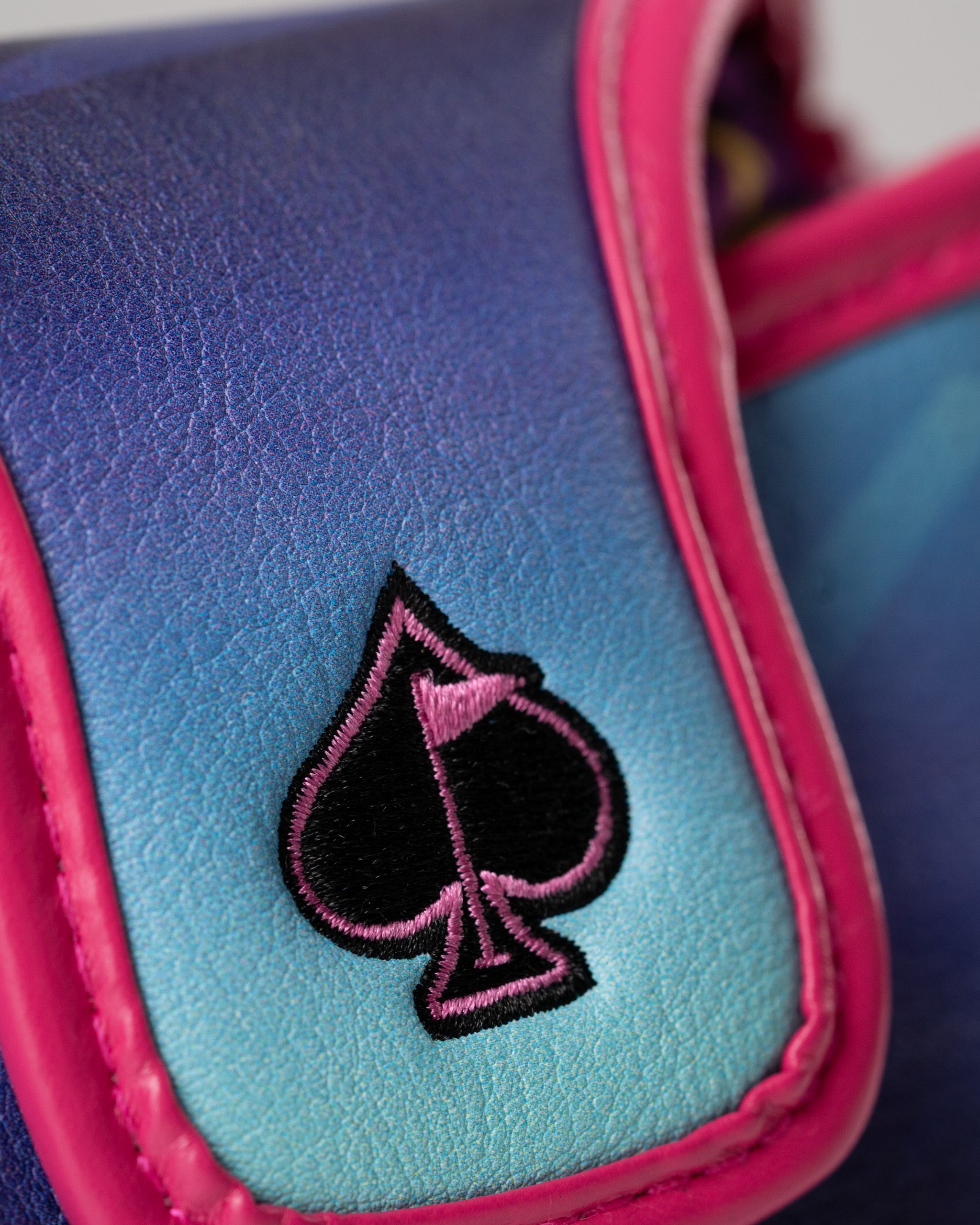 Vibrant blue and pink mallet putter cover featuring a black spade logo, perfect for stylish golfers.