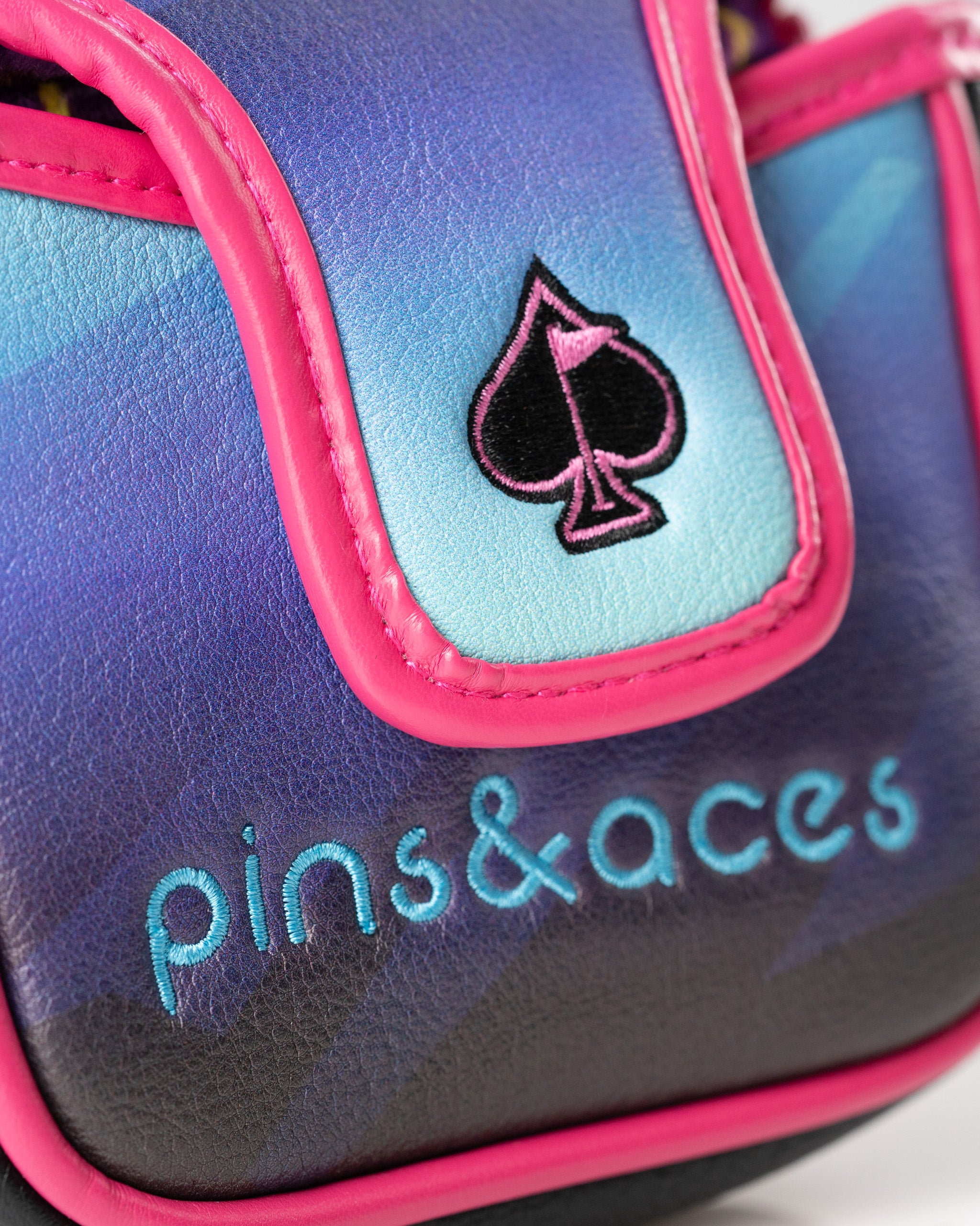 Bold Synthwave mallet putter cover featuring vibrant purple and pink colors with the Pins and Aces logo.