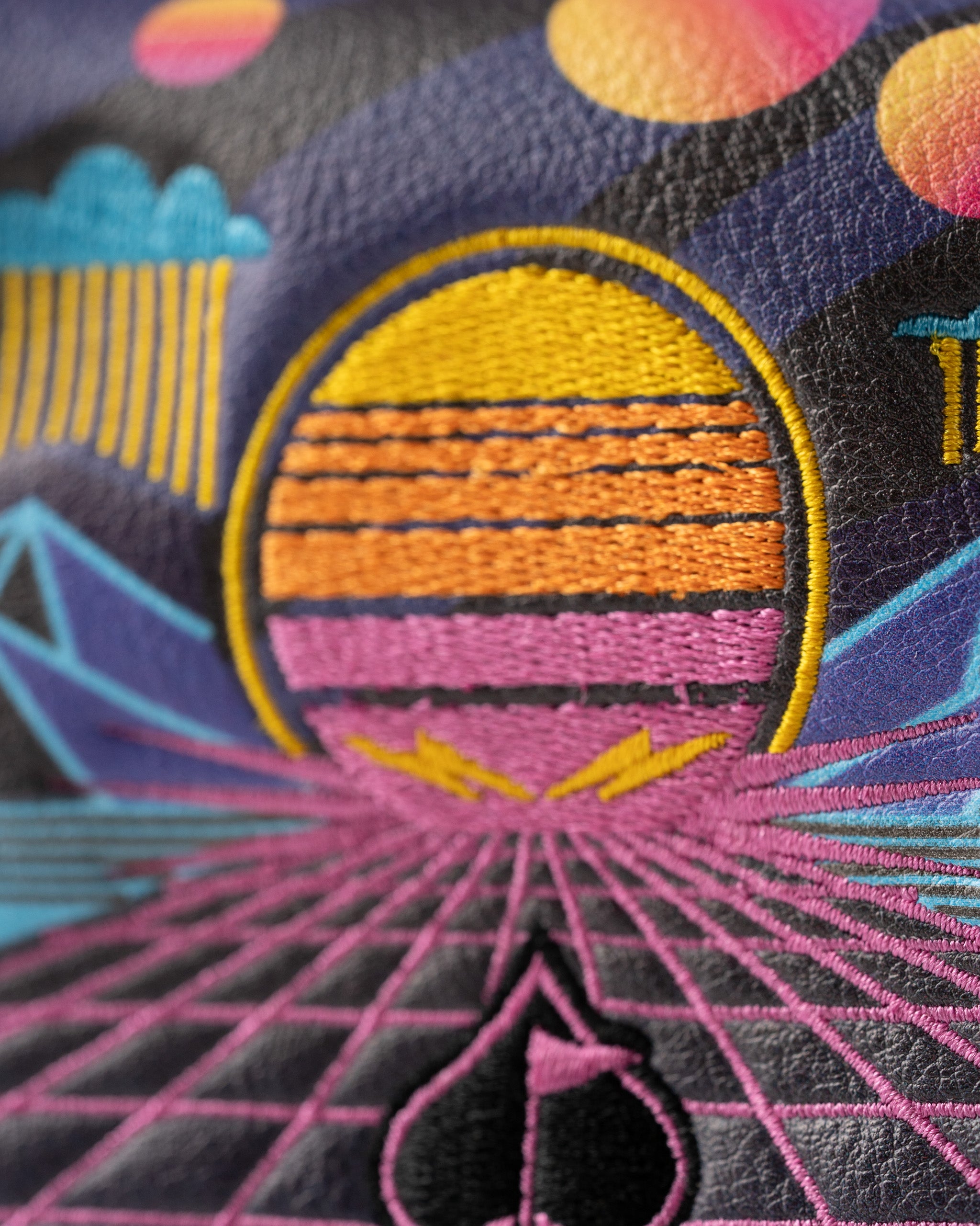Vibrant mallet putter cover featuring a retro synthwave design with a sunset and geometric patterns in bold colors.