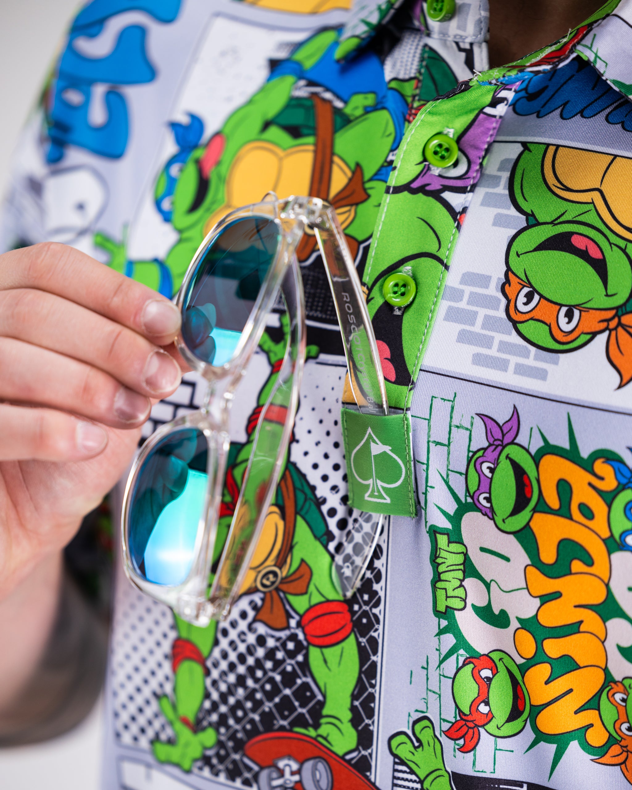 TMNT comic strip graphic on a polo shirt featuring the Teenage Mutant Ninja Turtles.