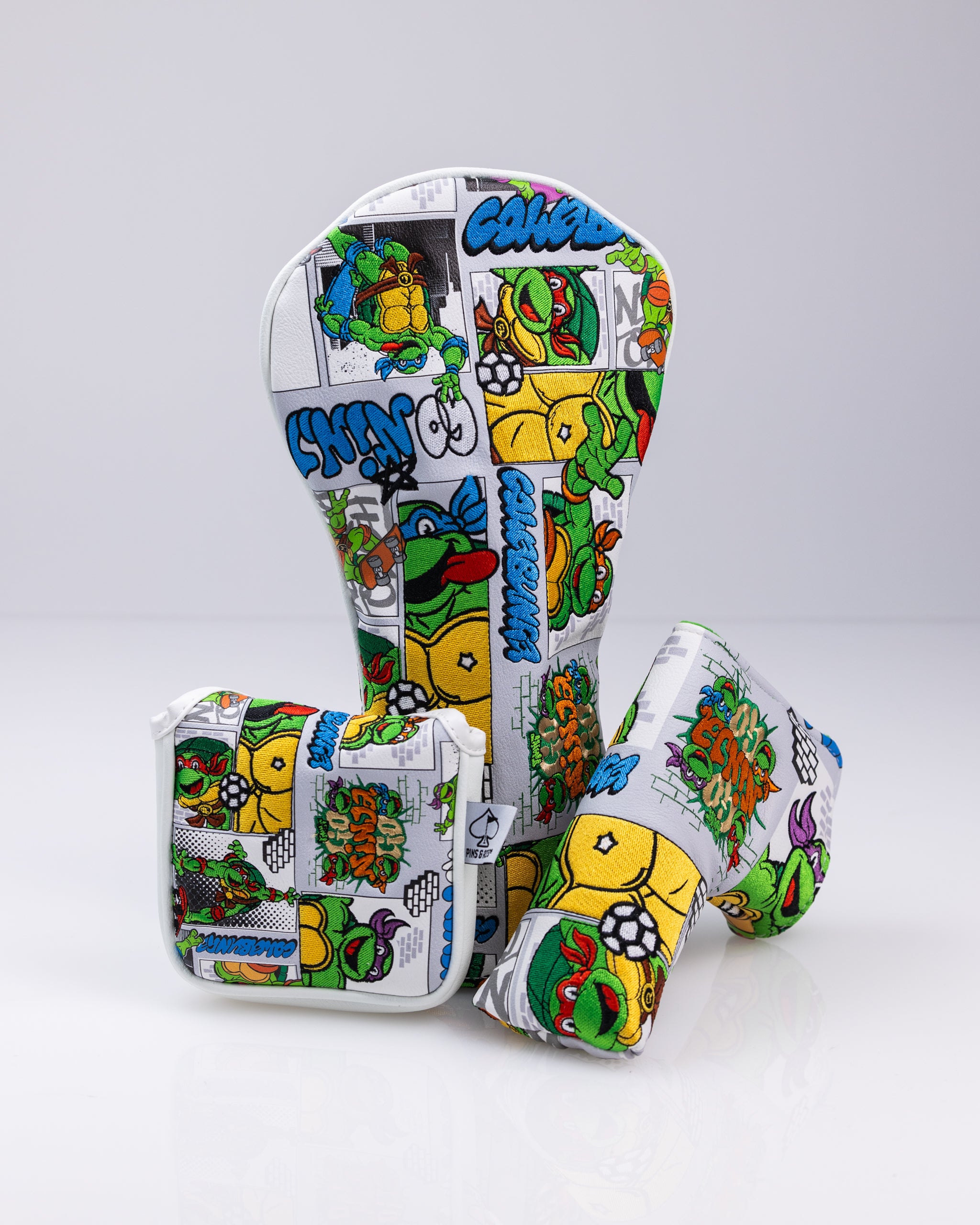 Colorful Teenage Mutant Ninja Turtles-themed golf headcover and accessories set with vibrant comic-style graphics.