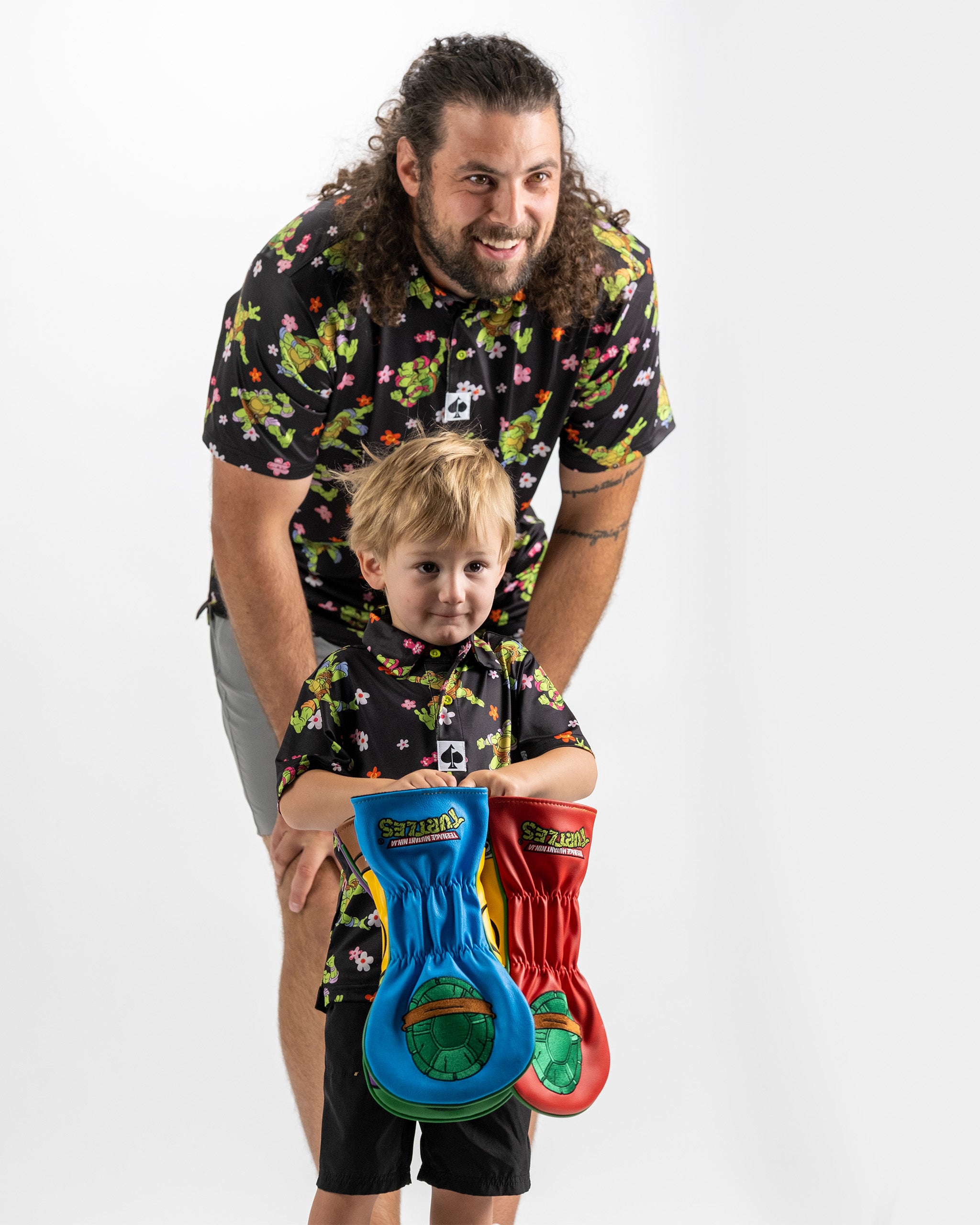 "TMNT Youth Turtle Flower Power polo shirt featuring vibrant turtle graphics and floral patterns."