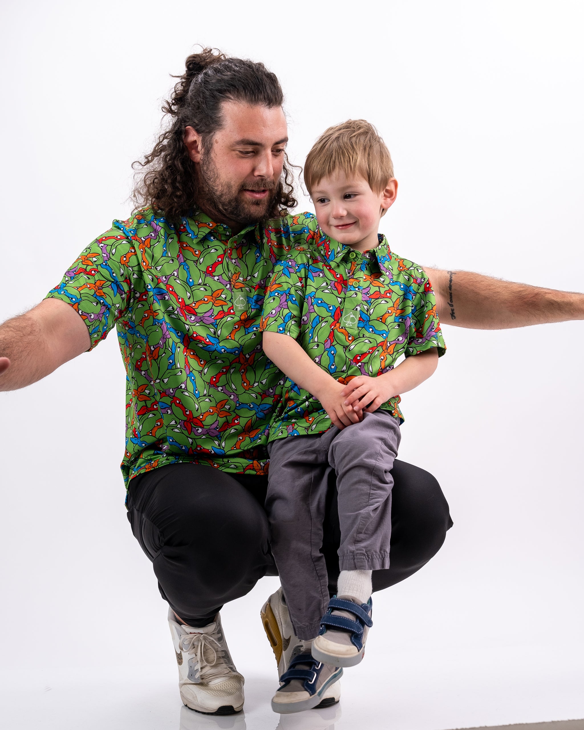 "TMNT Youth Mean Green t-shirt featuring a vibrant design of Teenage Mutant Ninja Turtles in green, modeled by a child."