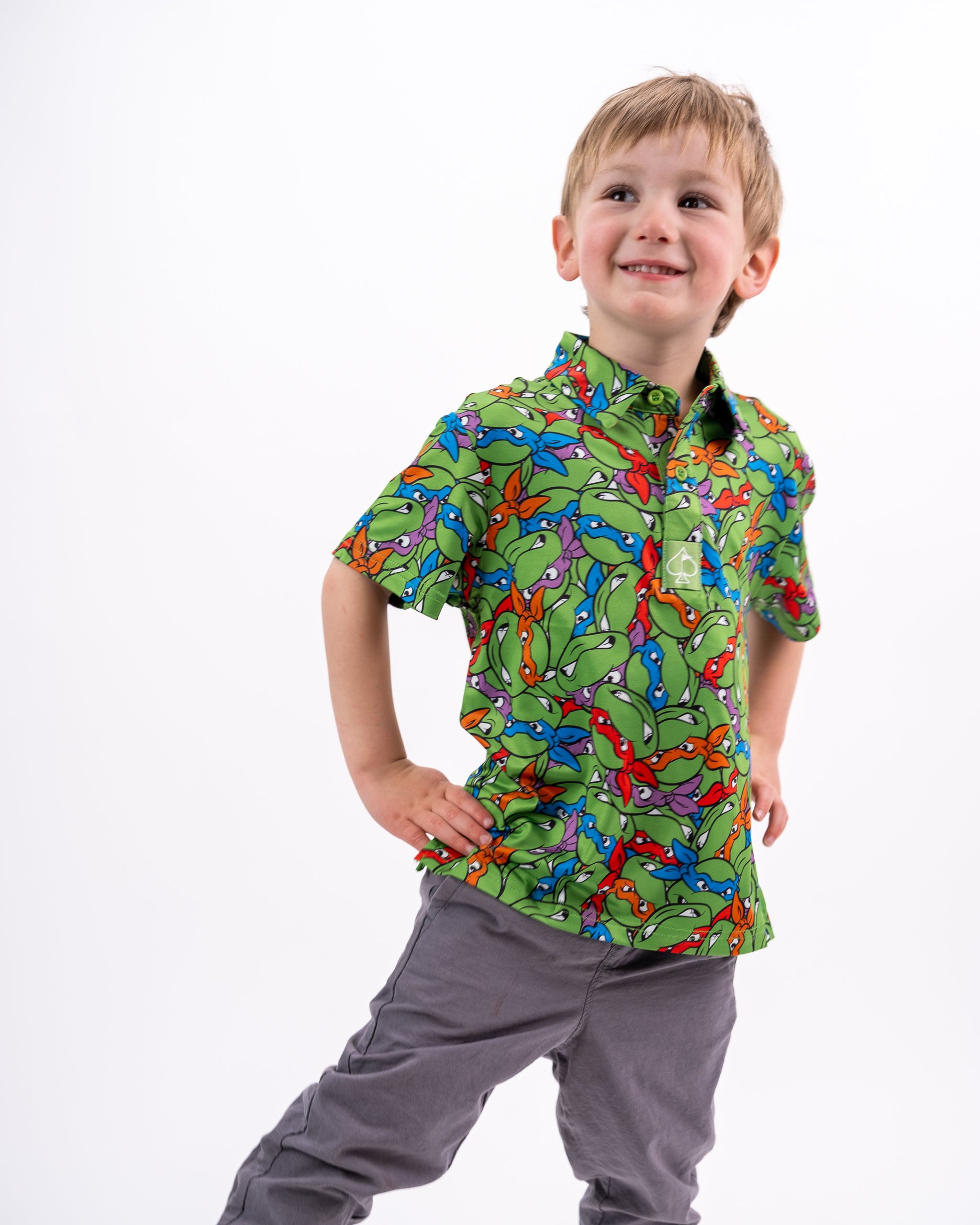 Youth TMNT Mean Green t-shirt featuring the Teenage Mutant Ninja Turtles graphic design, modeled by a child.