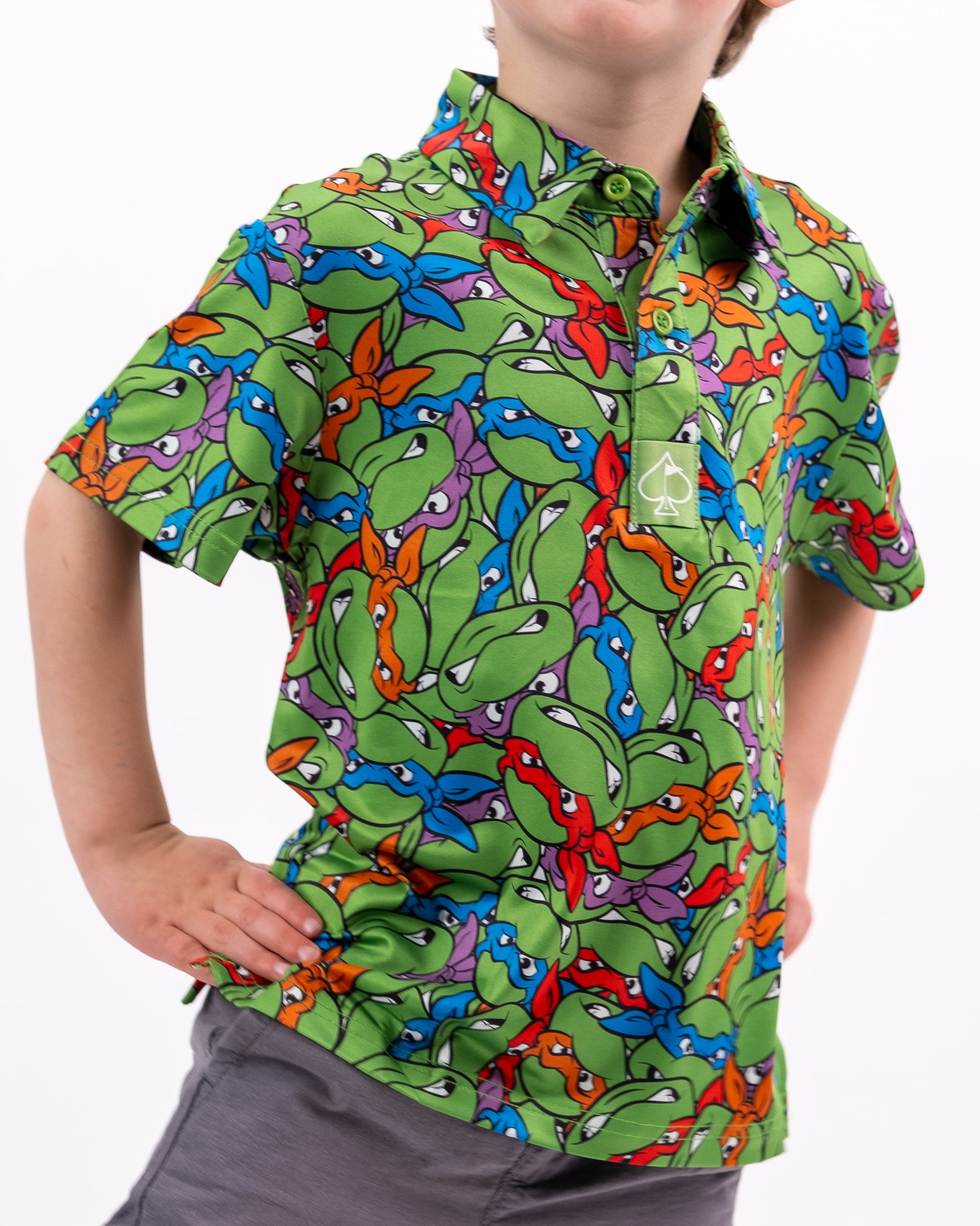 TMNT Youth Mean Green t-shirt featuring vibrant graphics of Teenage Mutant Ninja Turtles on a green background.