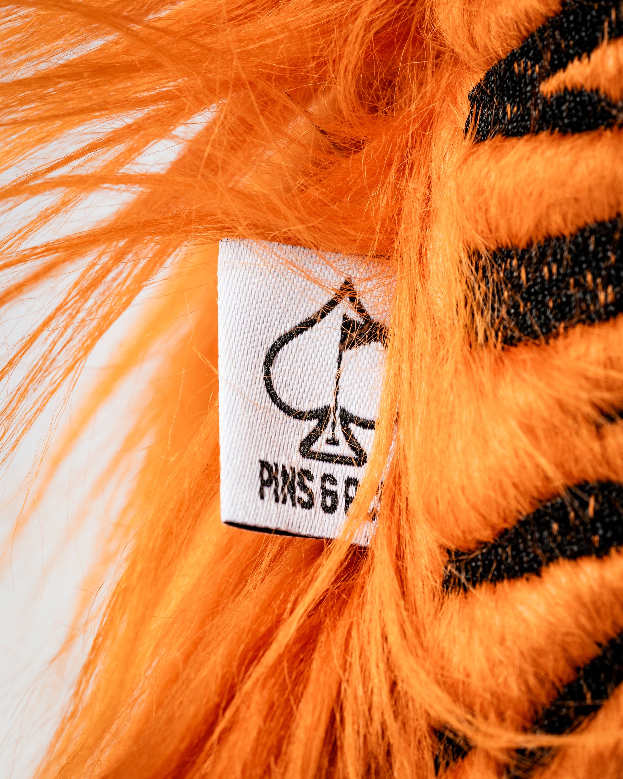 Bold orange tiger fairway cover with plush fur and a distinctive black stripe pattern, showcasing the Pins and Aces logo.