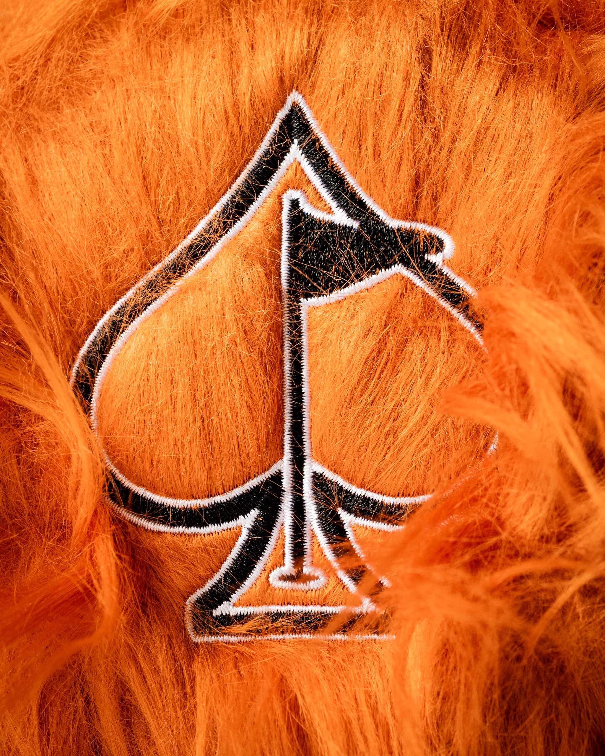 Bold orange tiger headcover set featuring a spade logo, designed for golfers who want to stand out on the course.