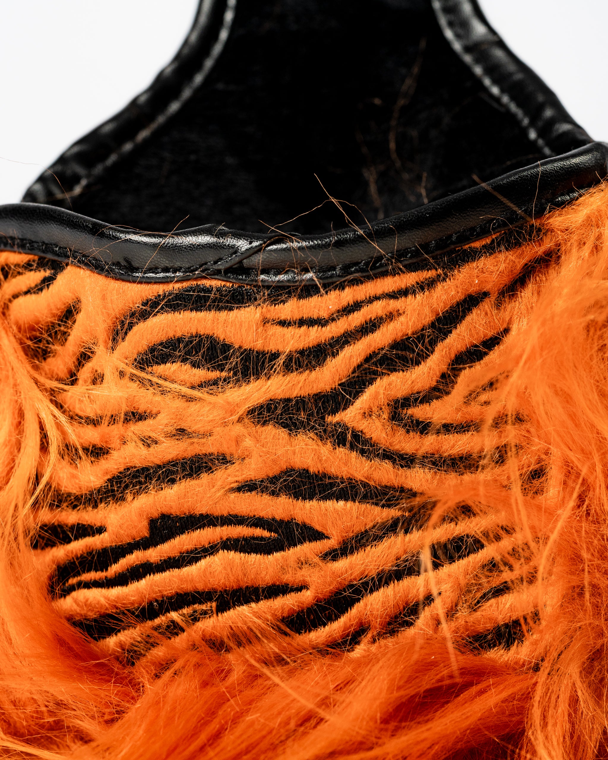 Bold orange and black tiger-striped mallet putter cover with a furry texture, designed for golfers who want to stand out.