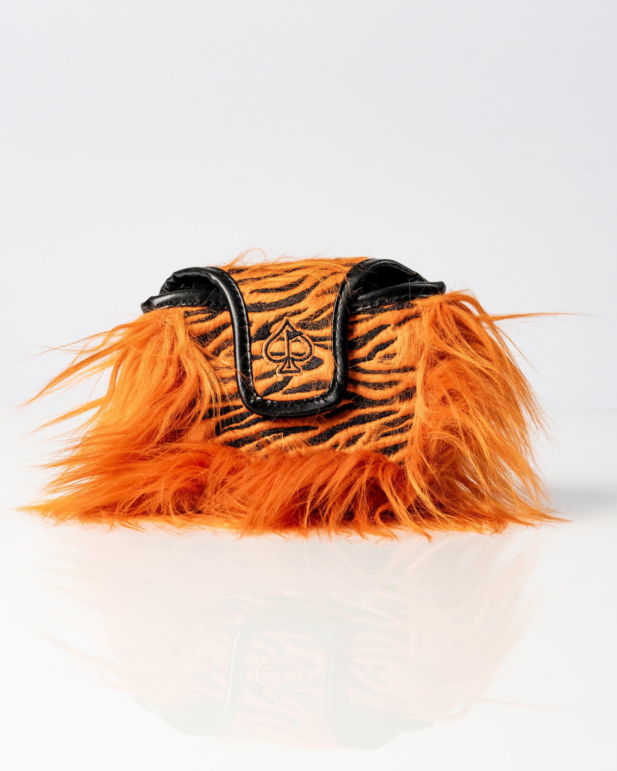 Bold orange tiger-striped mallet putter cover with black trim and a spade logo, designed for golfers who want to stand out.