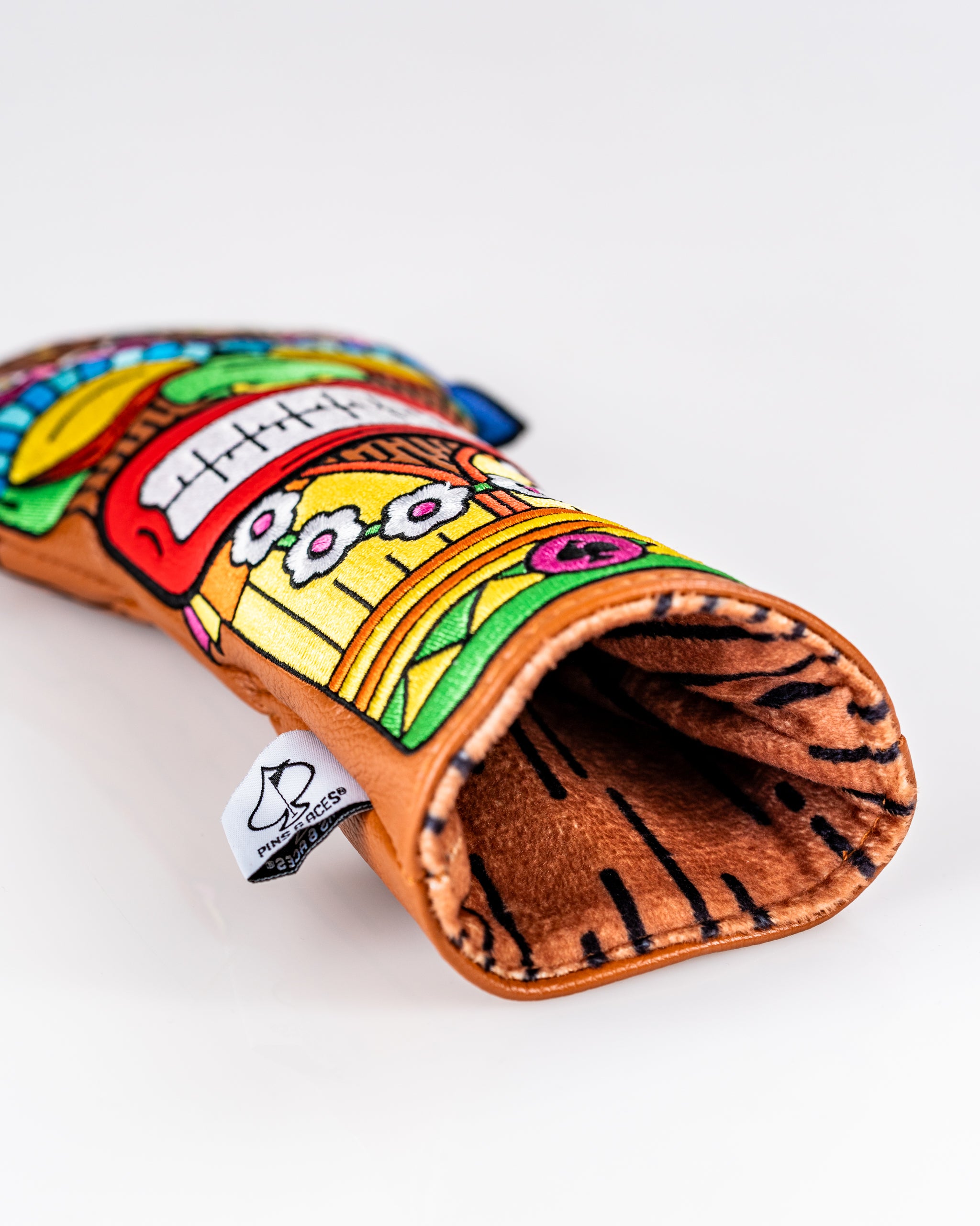 Colorful Tiki headcover set featuring vibrant designs, perfect for adding personality to your golf clubs on the course.