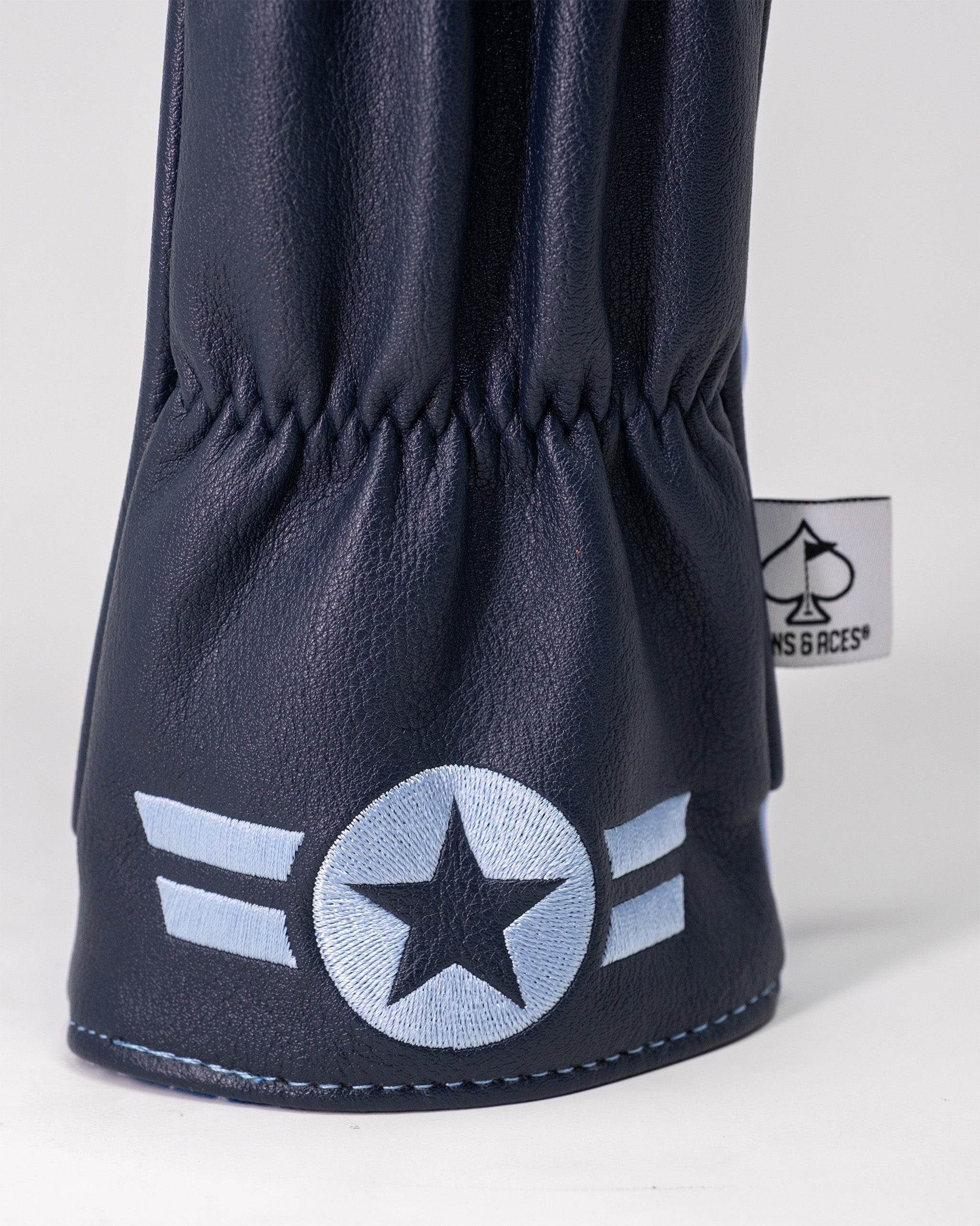 Top Gun Ice Man fairway headcover in navy blue faux leather with embroidered white star and stripes, featuring a sewn-in brand tag.