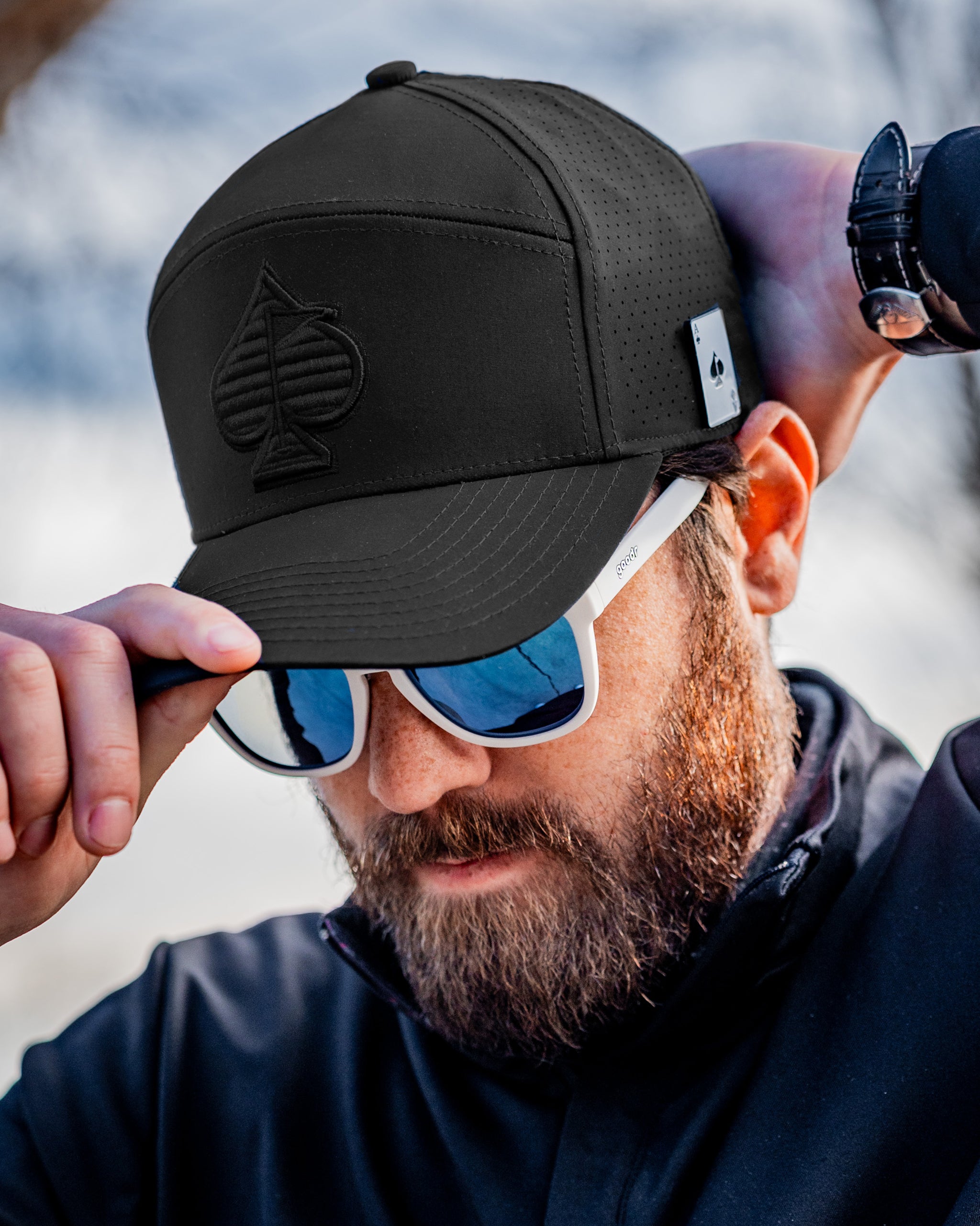 Tradesman Hat in black, showcasing a stylish and durable design, worn by a model in an outdoor setting.