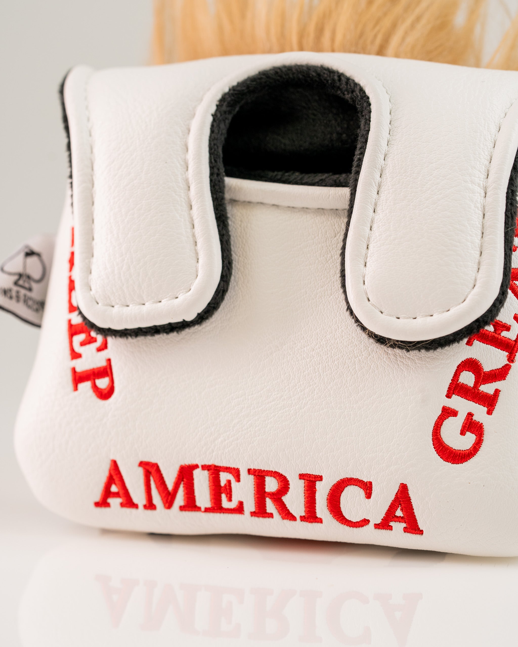 White mallet putter cover featuring bold red text that reads "Make America Great Again" with a unique design.