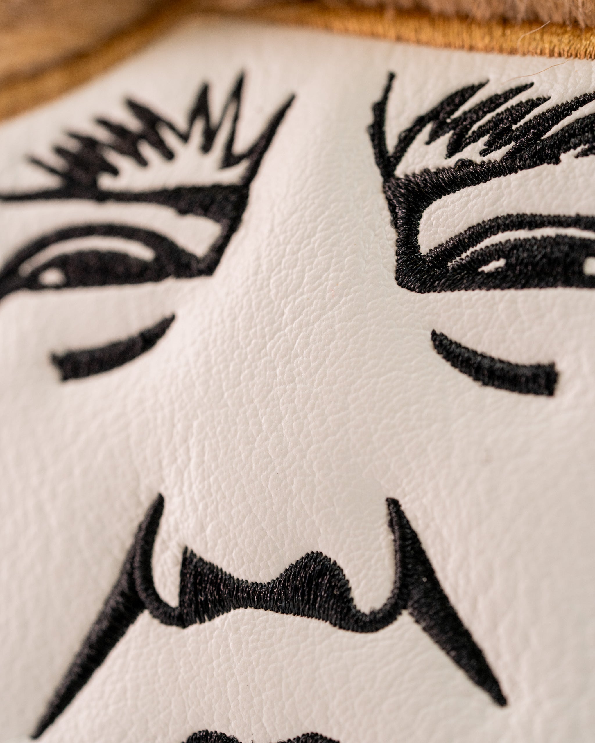 Bold mallet putter cover featuring a detailed embroidered face design, perfect for golfers wanting to stand out.