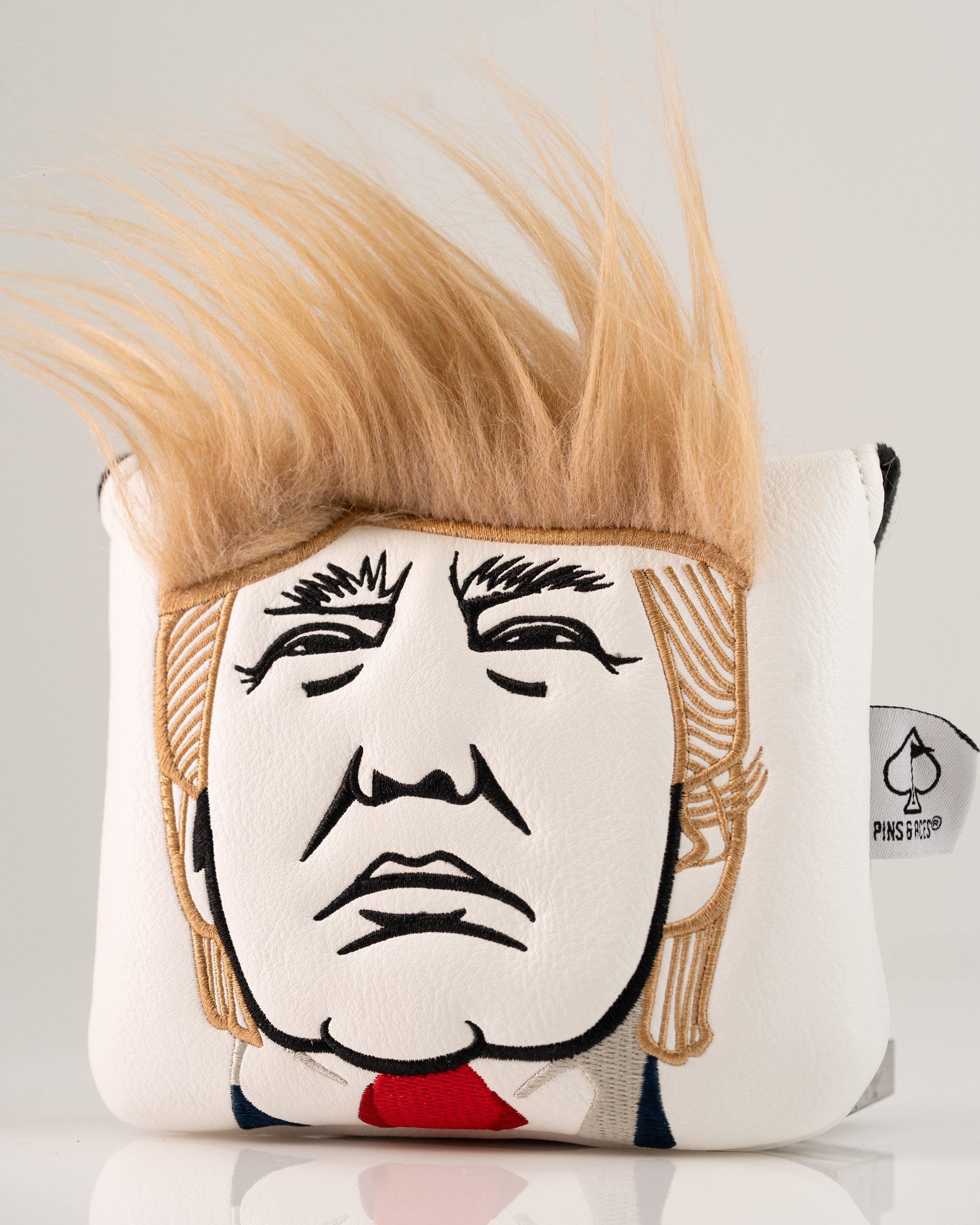 Trump center shaft mallet putter cover featuring a detailed embroidered face and distinctive blonde hair design.