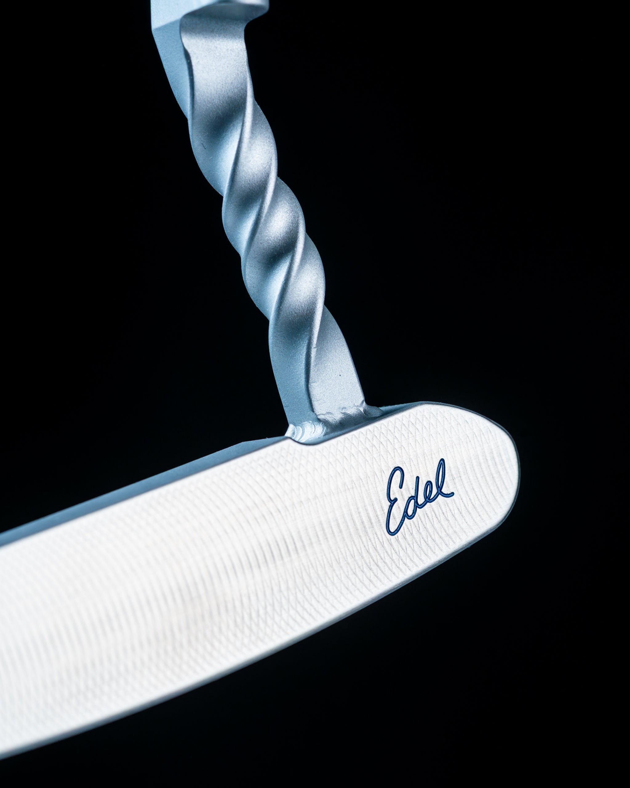 Edel Twister Putter with a unique twisted shaft and sleek white face, designed for precision and style on the golf course.