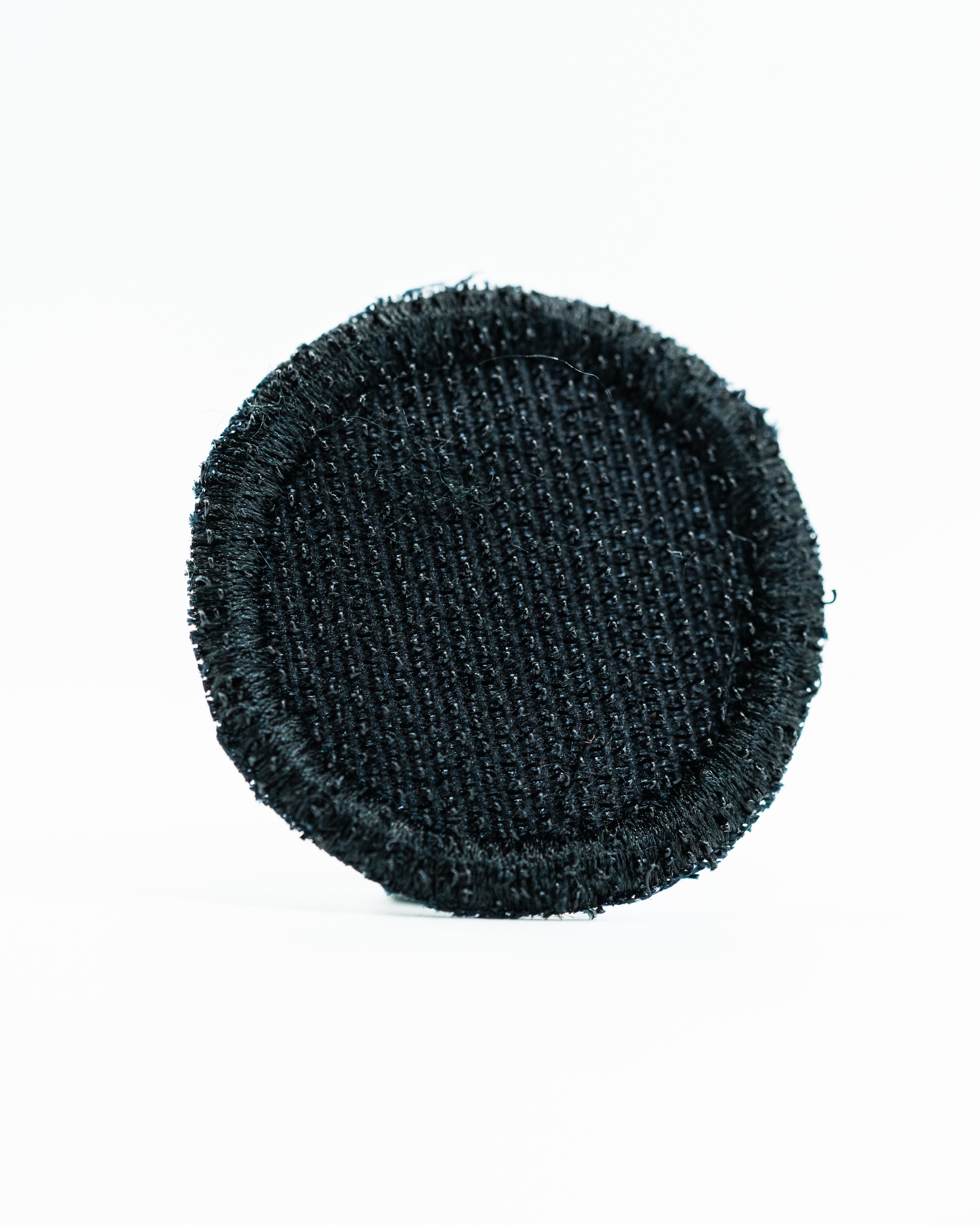 Black headcover patch with a textured surface, designed for golfers seeking a sleek and stylish accessory.