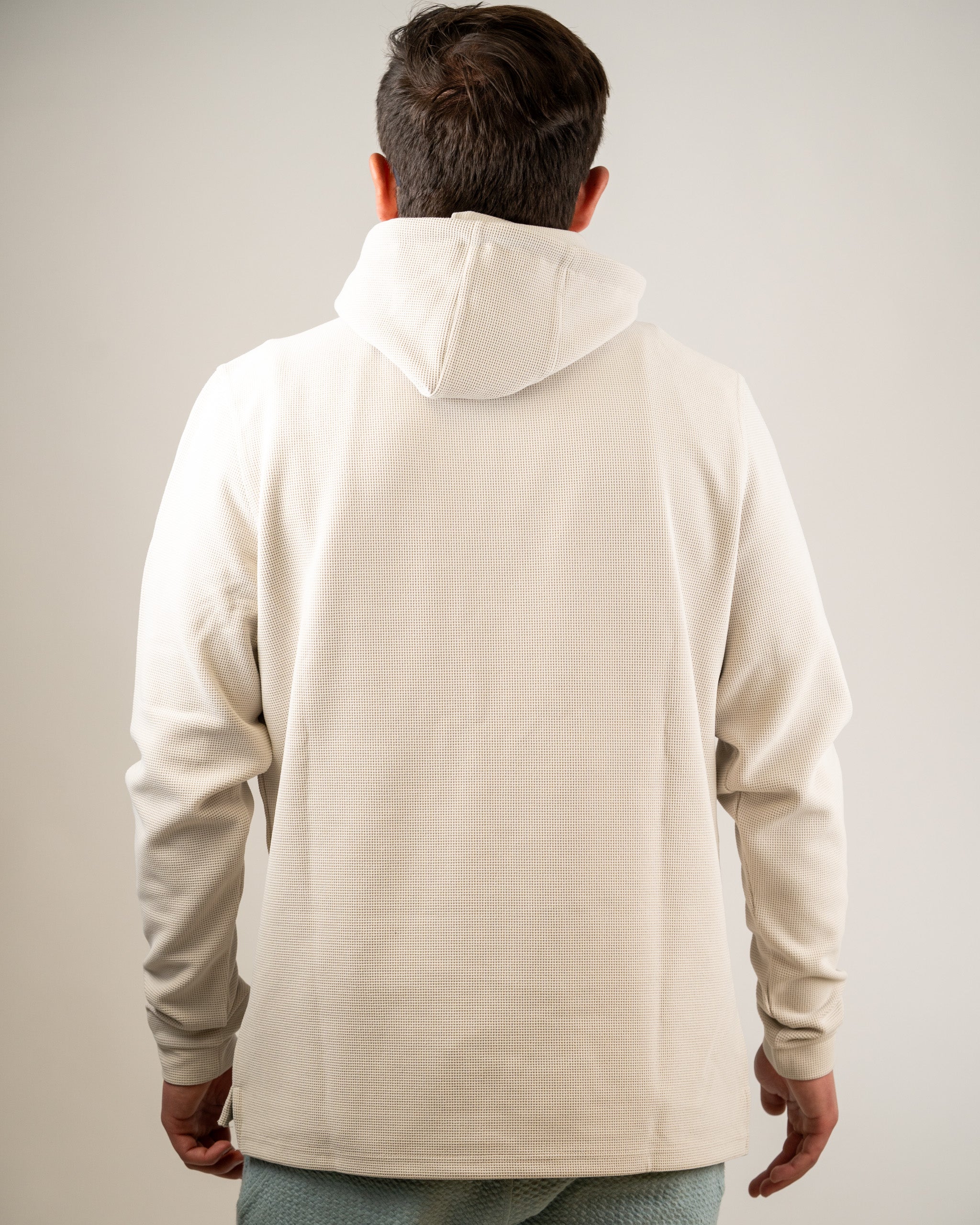 Men's dark stone waffle grid hoodie featuring a relaxed fit and adjustable hood, perfect for stylish comfort on the course.