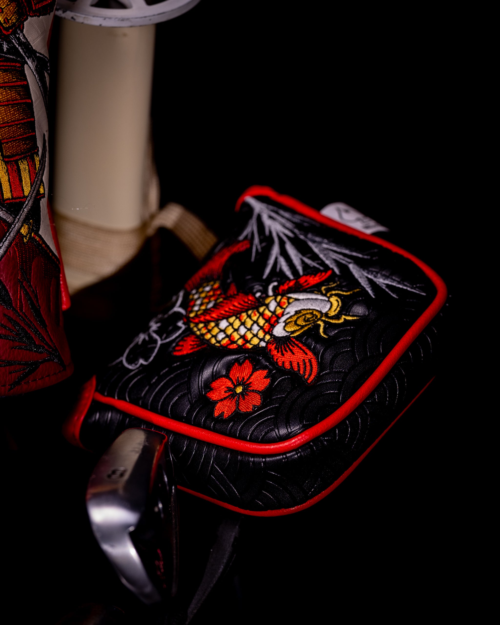 Koi Flow mallet putter cover featuring a vibrant koi fish design on a dark background.