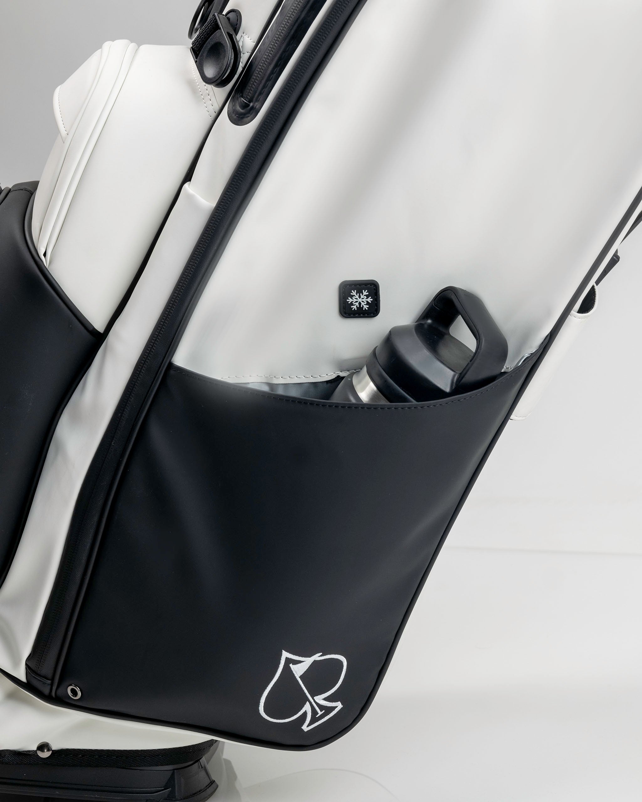 Player Preferred™ Golf Bag in Domino design featuring a sleek black and white pattern, with multiple pockets and a cup holder.