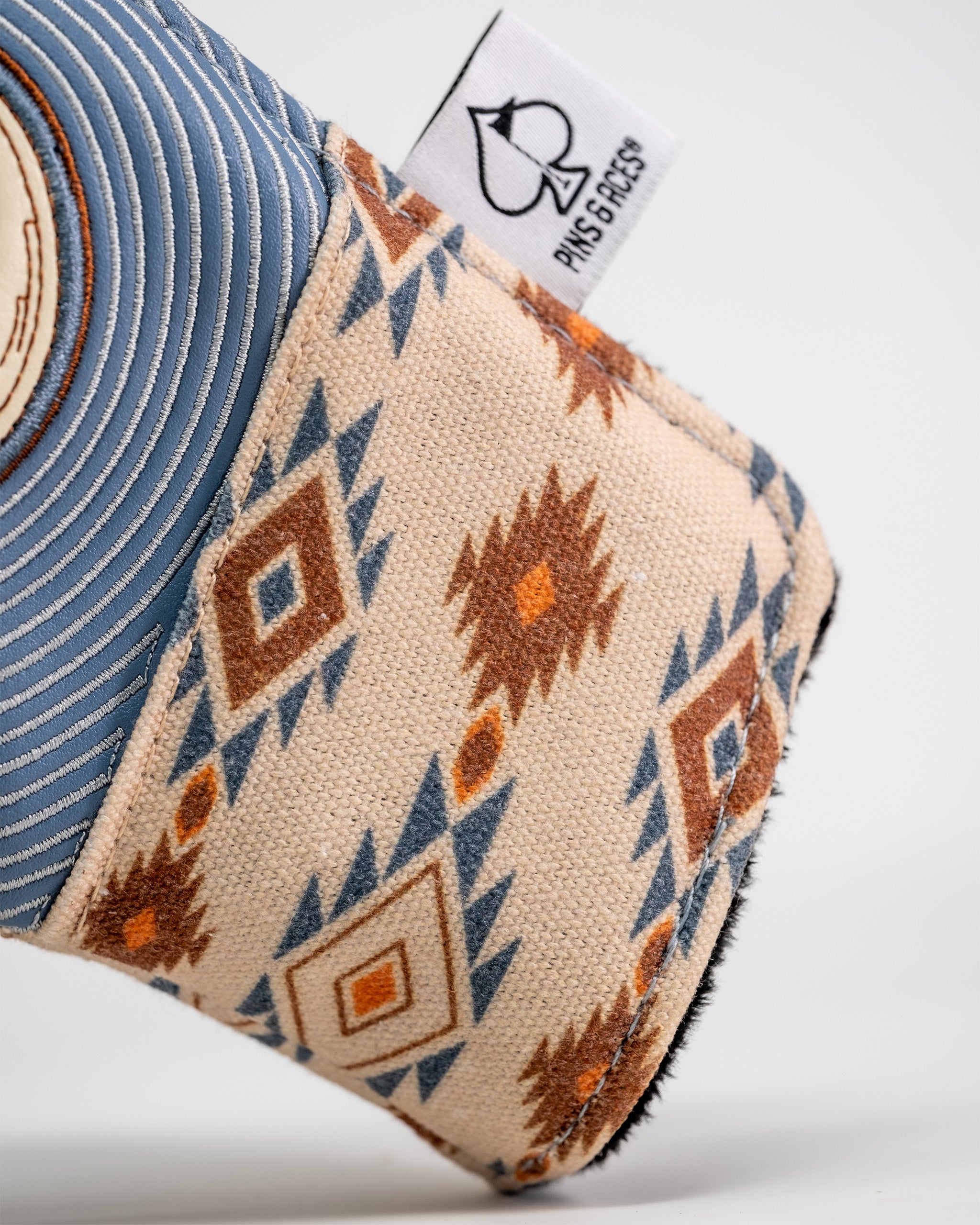 Western aesthetic blade putter cover with a southwestern-inspired geometric pattern in beige, brown, orange, and blue tones.