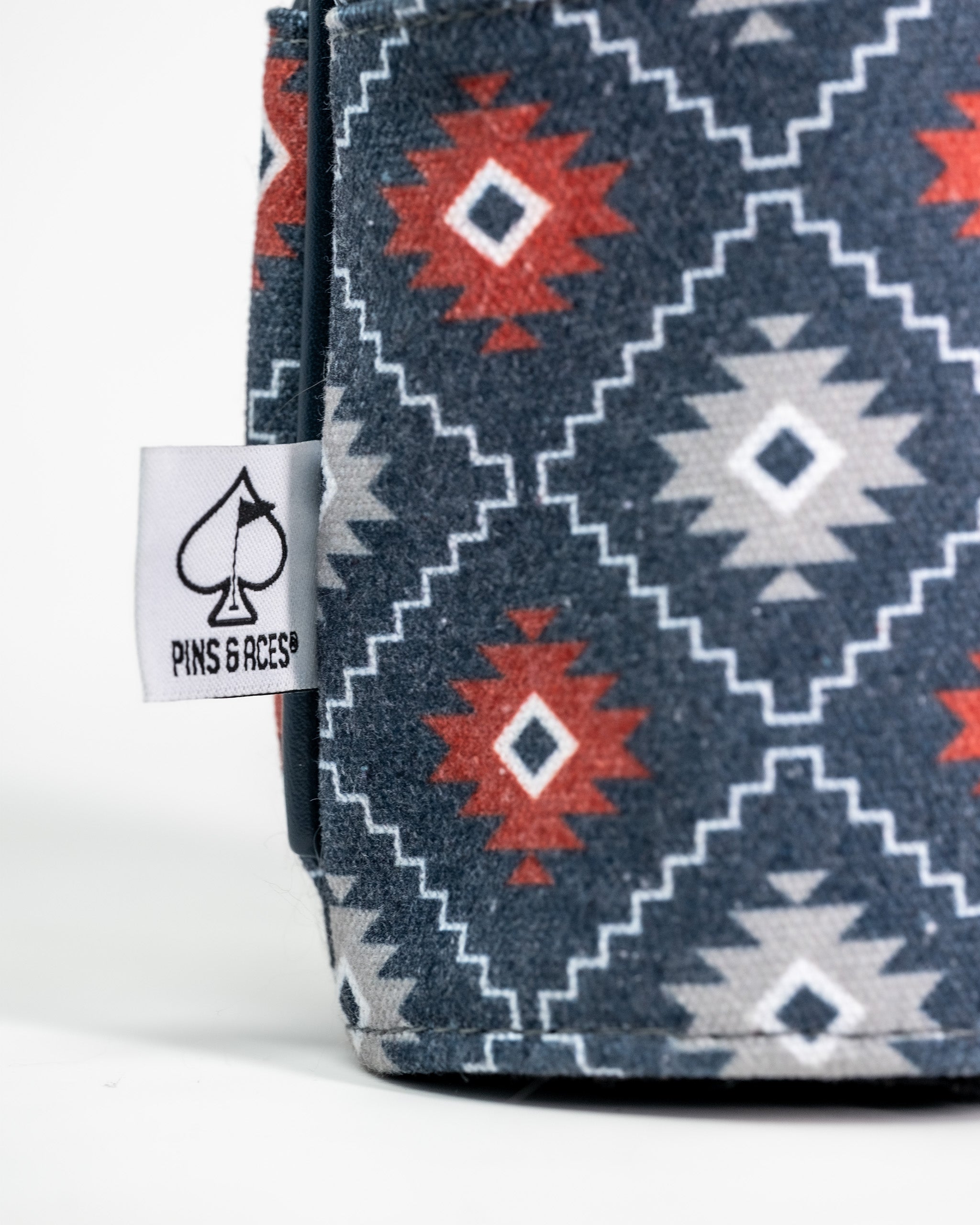 Western aesthetic golf fairway cover with a geometric southwestern pattern in navy, red, white, and gray colors.