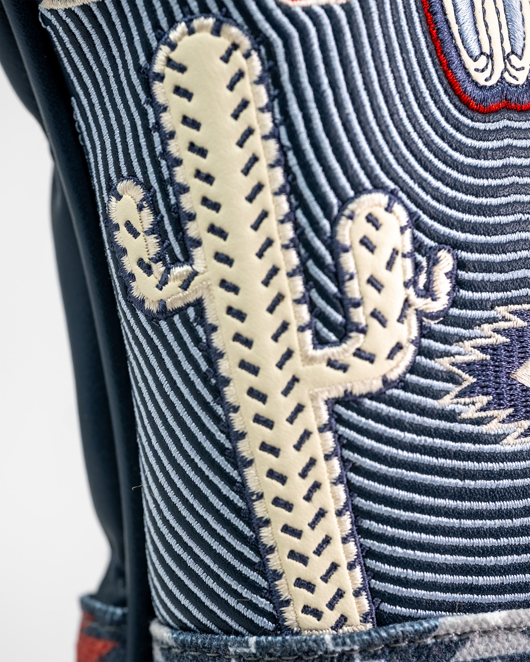 Close-up of a Western Aesthetic Fairway Cover featuring embroidered cactus design on striped fabric with detailed stitching.