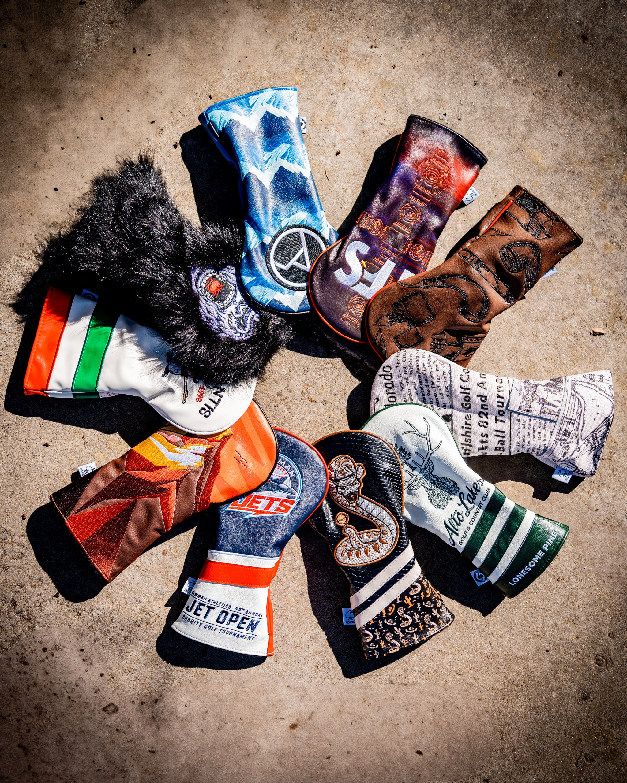 Colorful, bold golf headcovers with unique designs including animals, flames, and logos, perfect for standing out on the c...