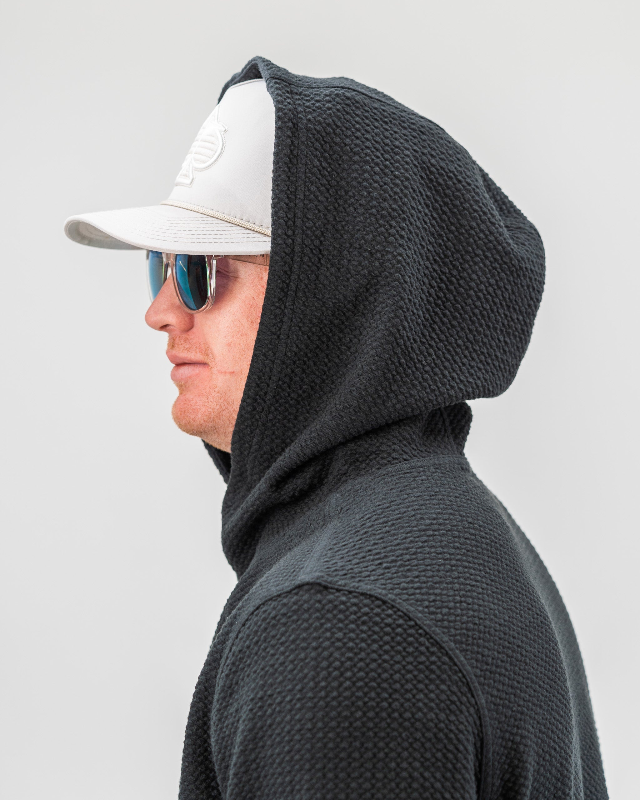 Black Player Preferred™ Waffle Knit Hoodie displaying a textured knit pattern, featuring a front pocket and adjustable drawstring hood.