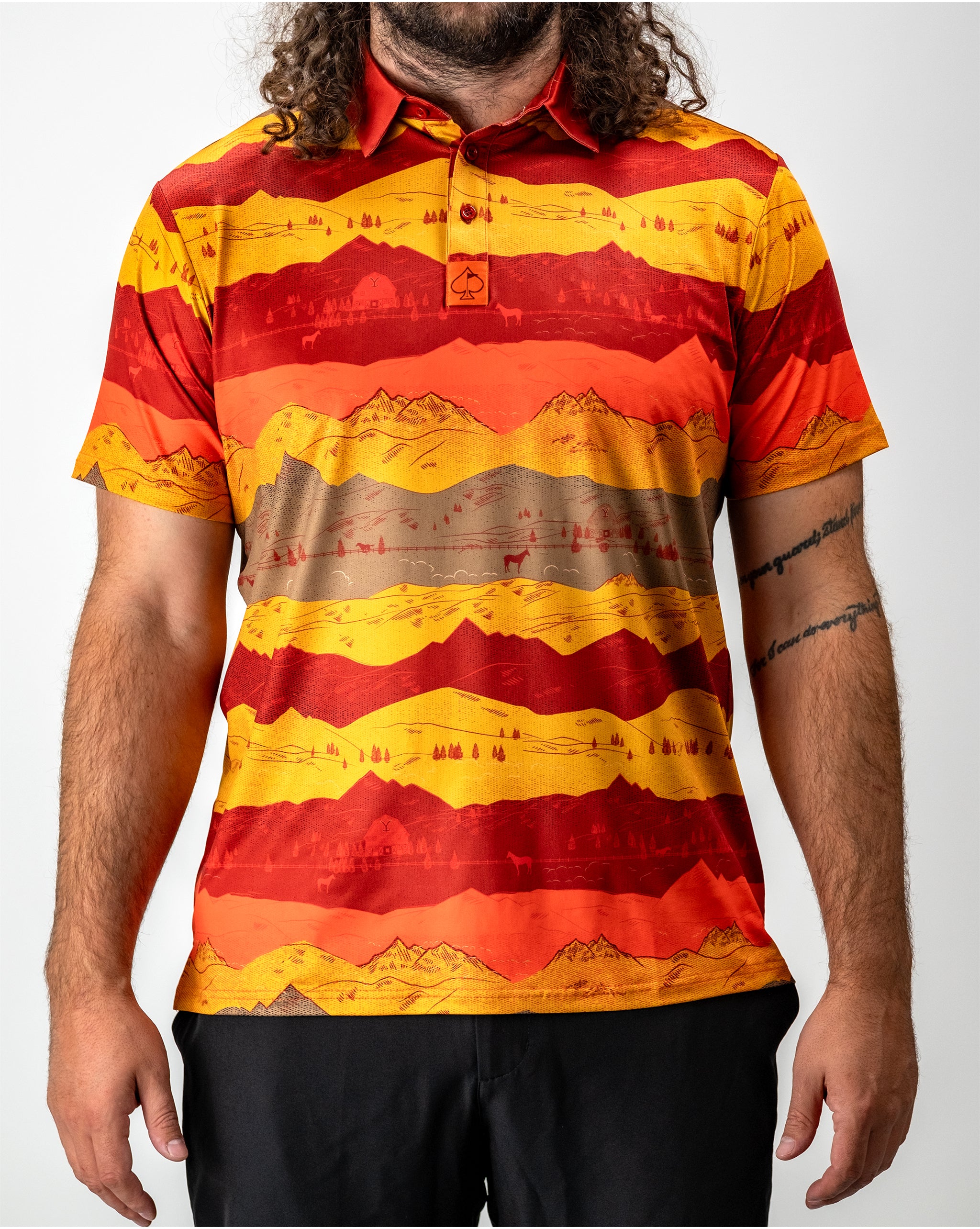 Sunset over Yellowstone National Park with vibrant orange and purple sky reflecting on calm water.