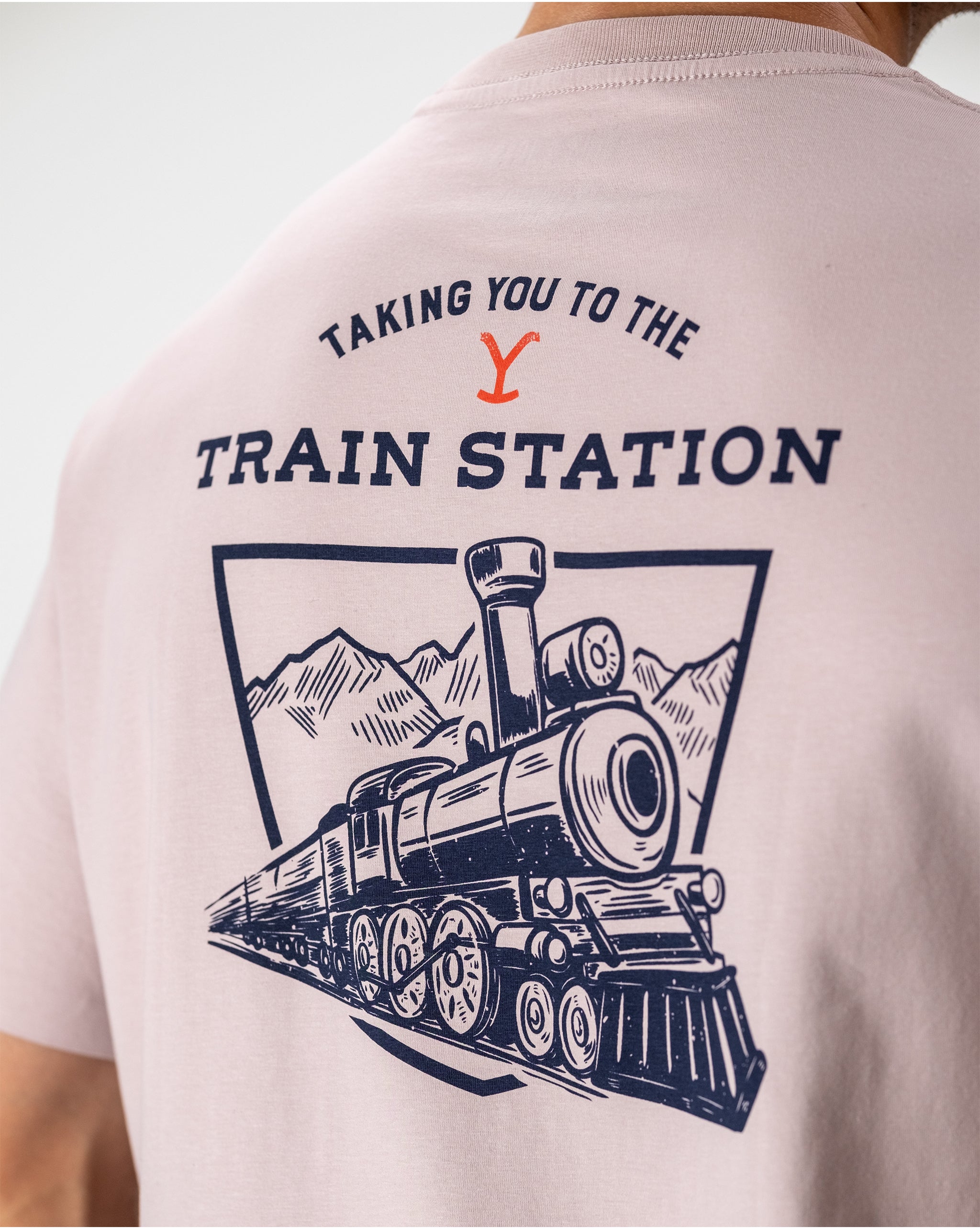 Yellowstone Train Station Tee featuring a vintage-style design with the iconic Yellowstone National Park logo in a distressed finish on a soft fabric.