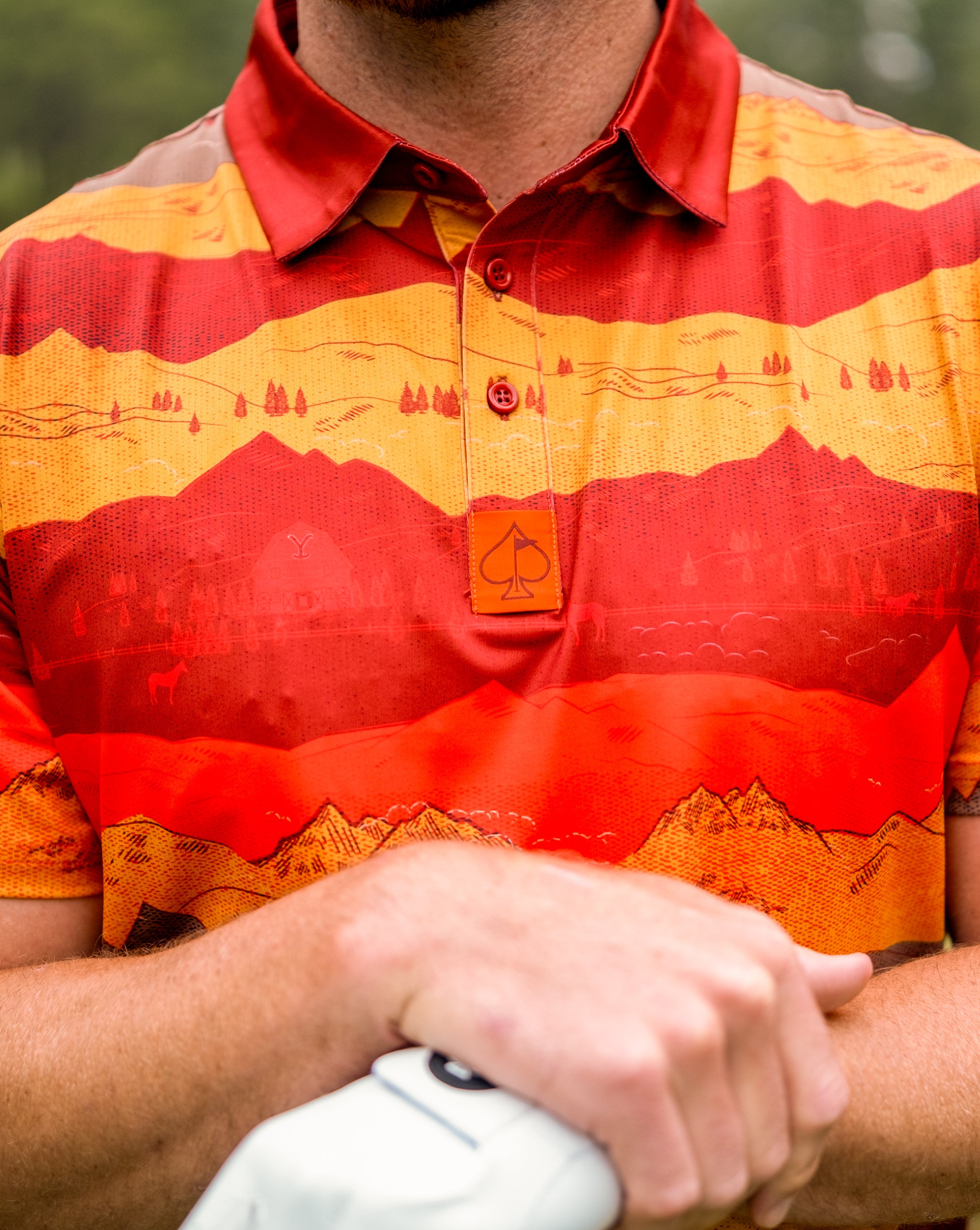 Yellowstone National Park sunset with vibrant orange and purple skies over sweeping landscapes and silhouetted mountains.