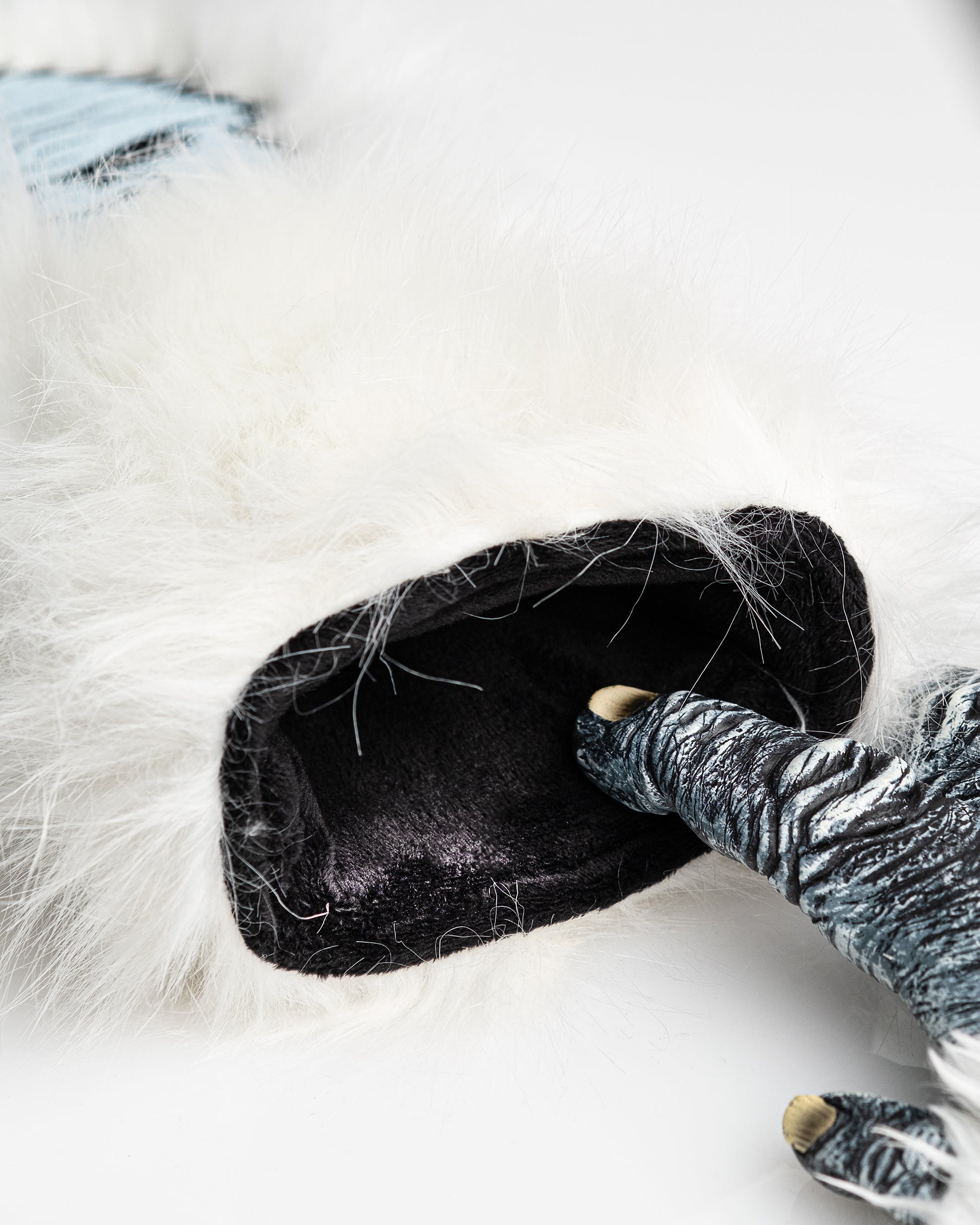 Close-up of a white faux fur headcover with black interior, featuring a golfer's gloved hand inserting a club. Perfect for...