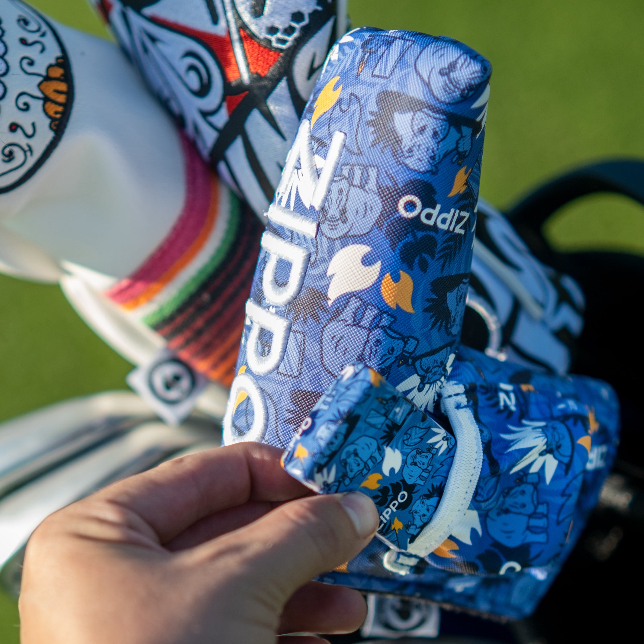 Colorful, patterned golf headcover with bold blue, white, and yellow graphics, designed to stand out on the course.
